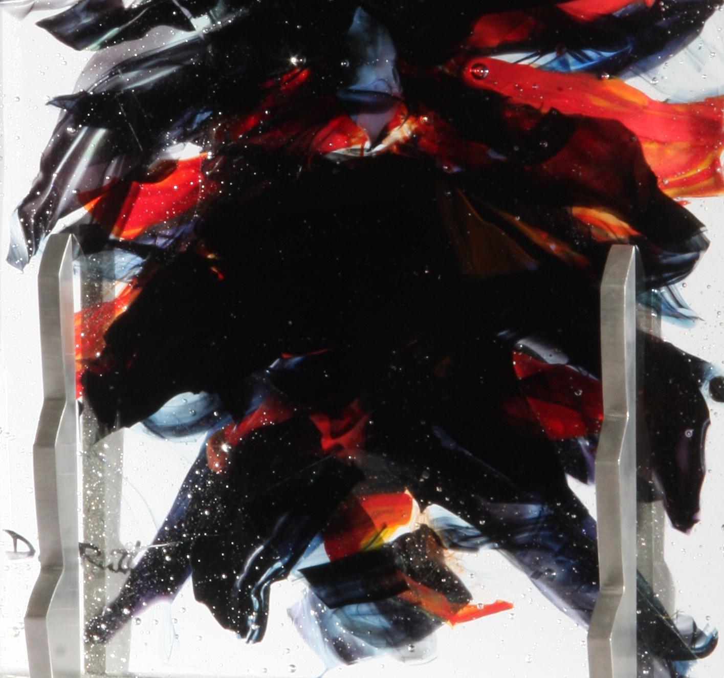 'Yaroi' is a contemporary abstract cast glass sculpture by David Ruth from his Internal Space series. It features painterly brushstroke formations in glass called trails. These trails are in colors of black, orange, blue and red. Trails are created