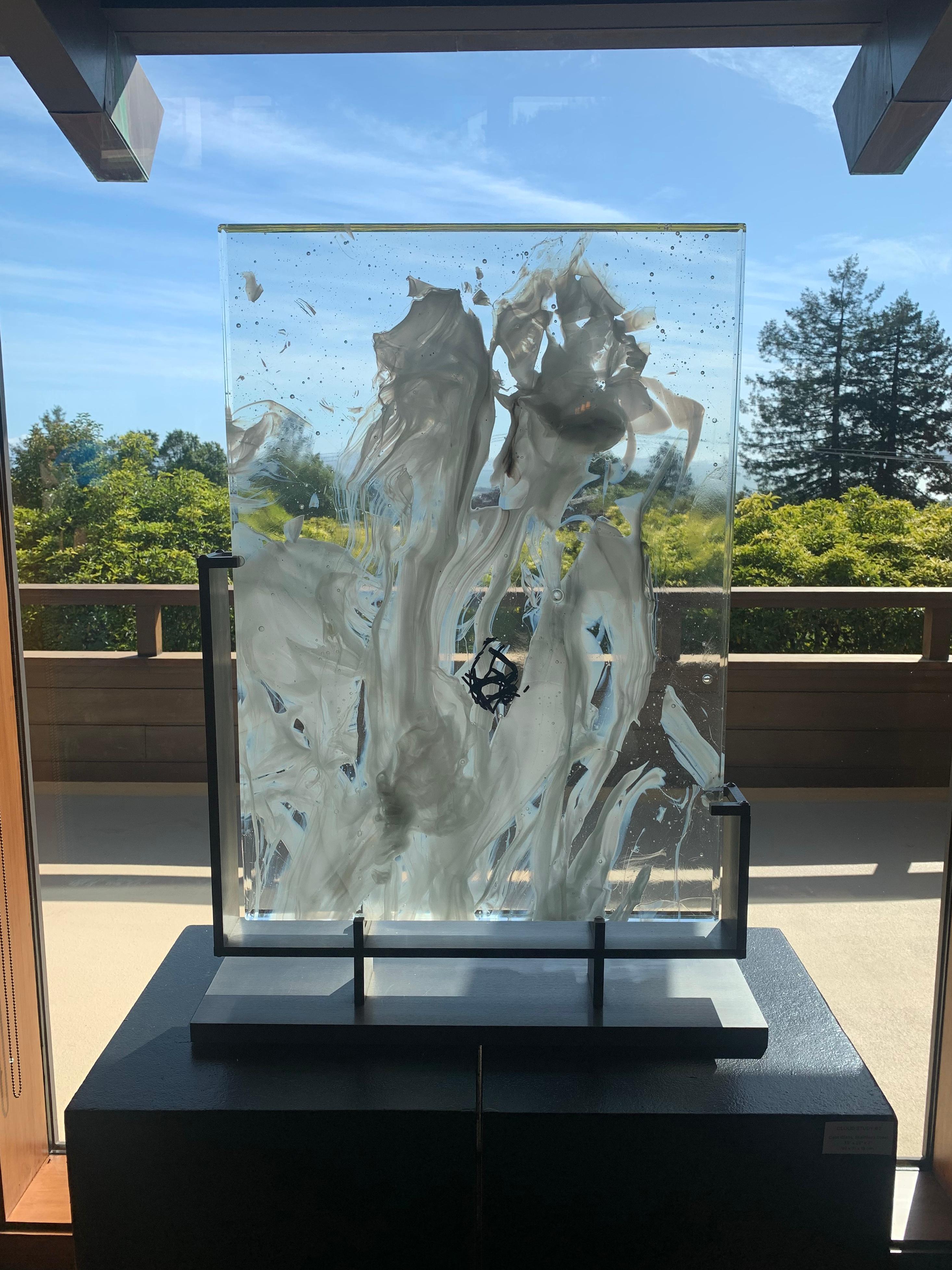 Cloud Study #2 is a contemporary abstract glass sculpture by David Ruth from his Cloud Study Series. It contains hues of white and black painterly brushstroke formations in glass called trails. Trails are created through rolling molten glass into