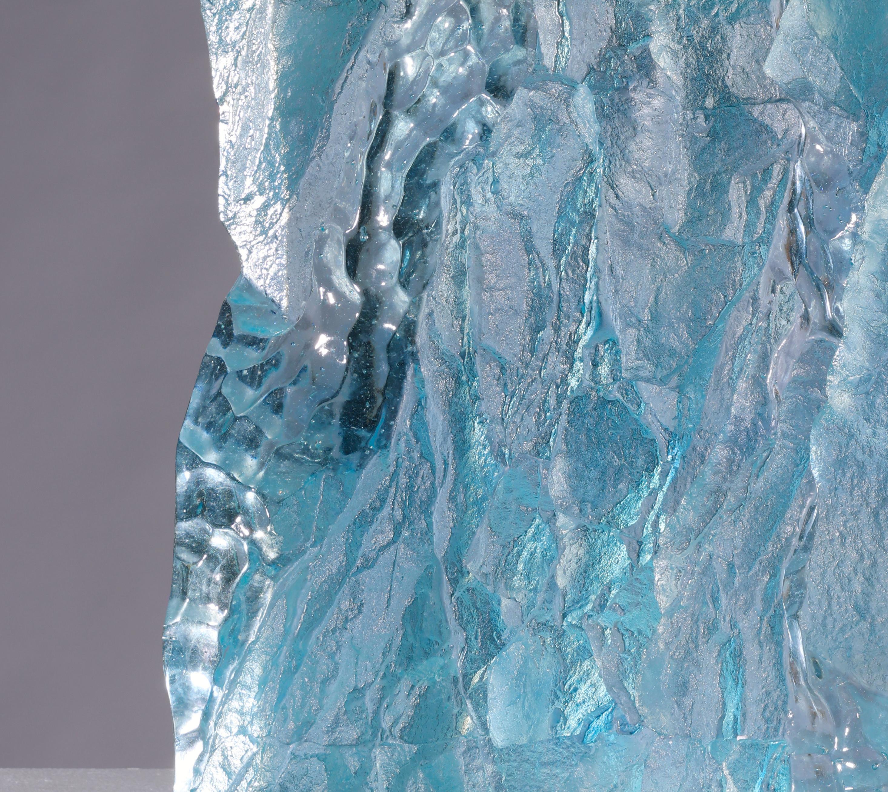 'Norsel 2' is a contemporary cast glass sculpture by David Ruth from the Chill Project Series. This sculpture is made from up of soda glass mixed with cobalt to create the ice blue color. The piece is initially derived from textures taken off ice