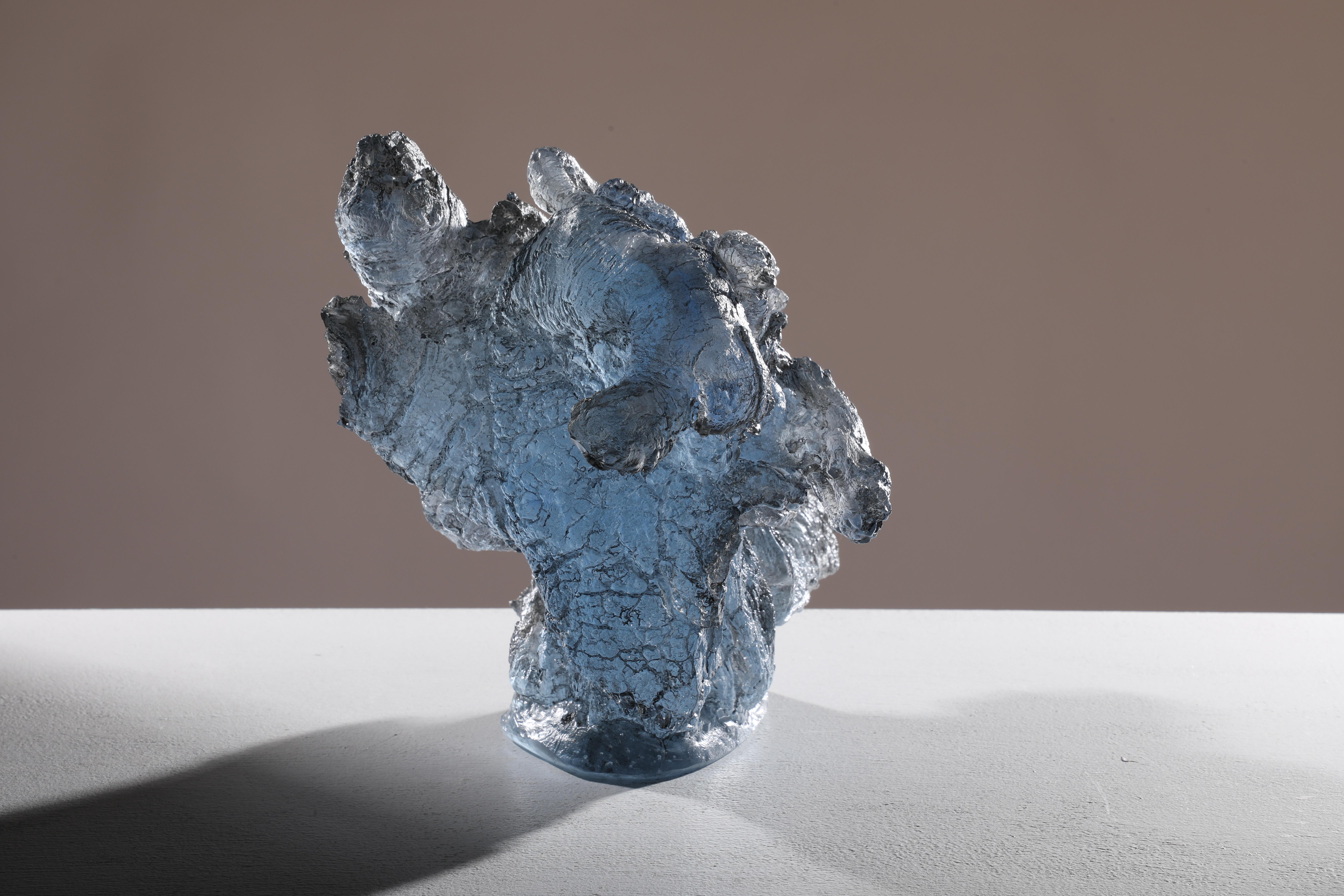 'Ulu Oti' is a contemporary cast glass sculpture by David Ruth from the Chill Project Series. This sculpture is made from soda glass that was then mixed with cobalt and copper to create the light blue color. The piece is initially derived from a