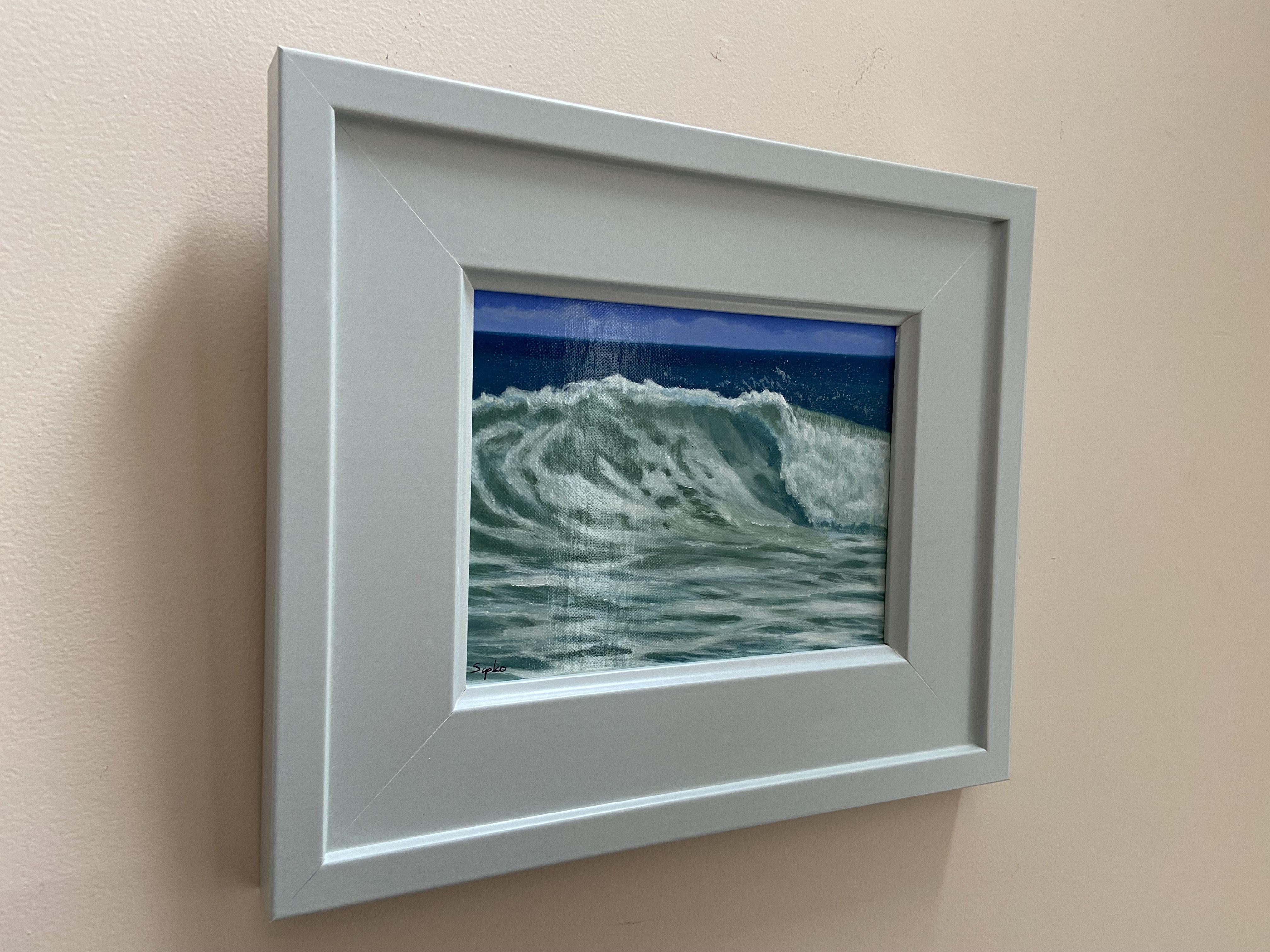 This is framed and ready to hang seascape of a breaking wave near the shore.  This piece is an oil on a linen panel and varnished to a glass like finish.  It has been framed in a cool gray wooden frame.  I love the ocean and am often times