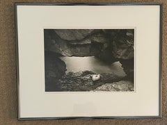 From A Single Grain, Nude Curled On Rock Landscape