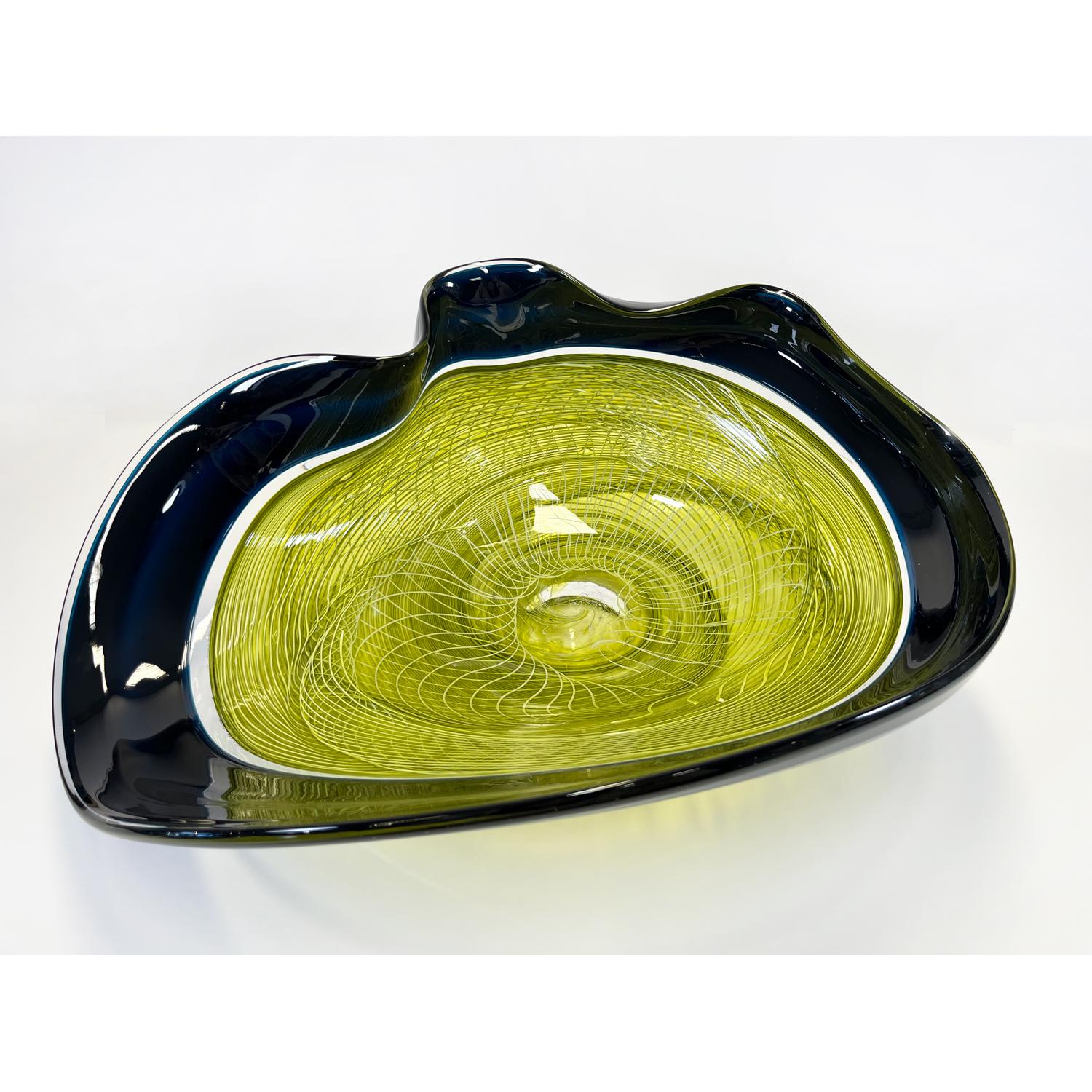 This Seagreen/Olive Rondelle Bowl is a continuation of David's work with cane. Fusing his signature wave bowl motif with his newer rondelle cane pattern. This beautiful glass bowl is sure to be a showstopper in your space. 

David Thai is a Chinese