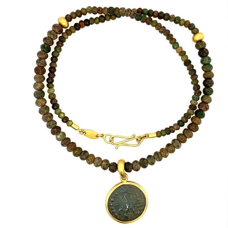 One-of-a-kind 22K framed ancient Roman coin on a necklace made of ancient Roman glass from the reign of Marcus Aurelius Probus. The reign of Probus was mainly spent in successful wars by which he re-established the security of all frontiers. The