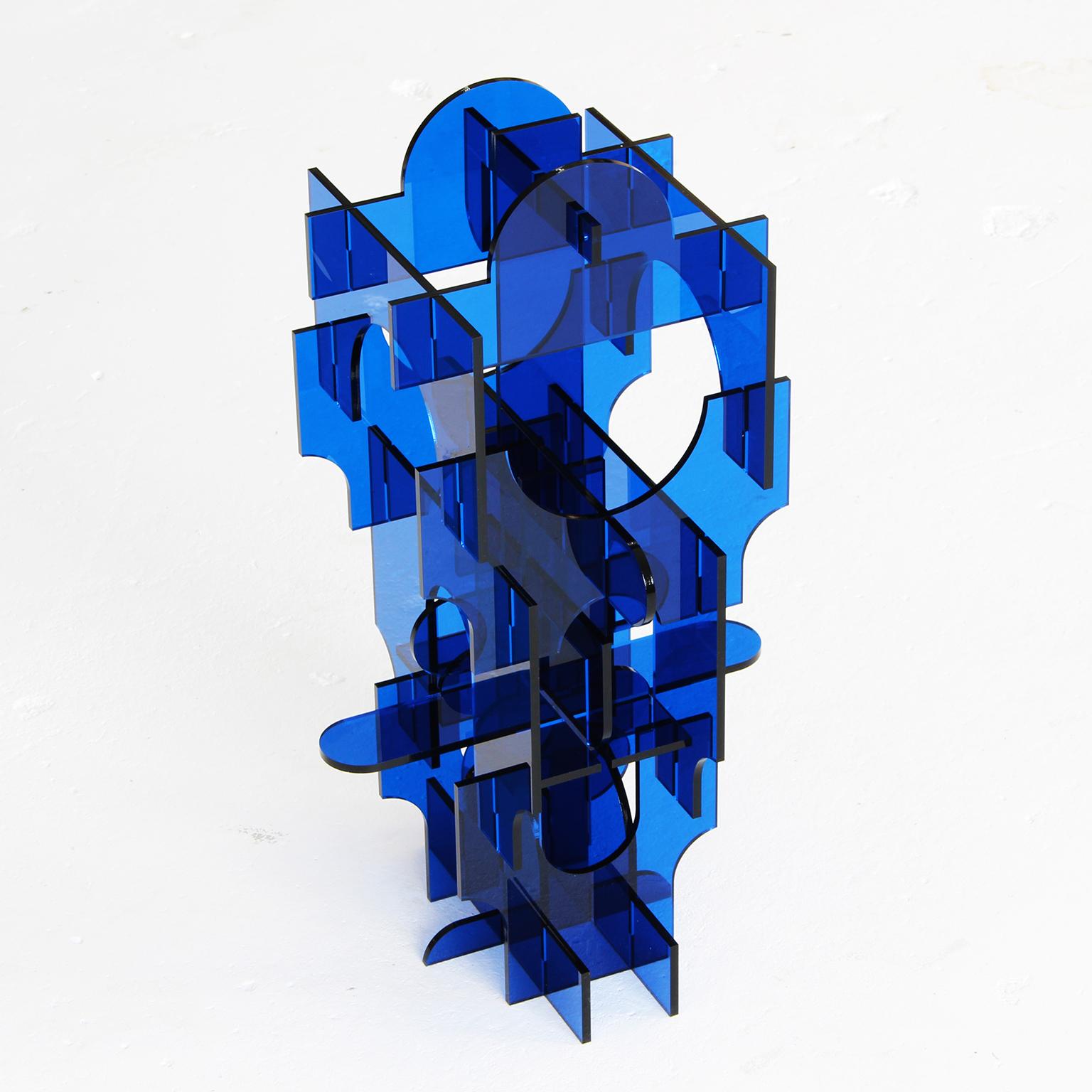 22-piece acrylic assemblage (no glue)
Material: 1/4 in transparent blue acrylic

The works of David Umemoto stand as studies about volume. At the juncture of sculpture and architecture, these miniature pieces evoke temporary buildings or monuments