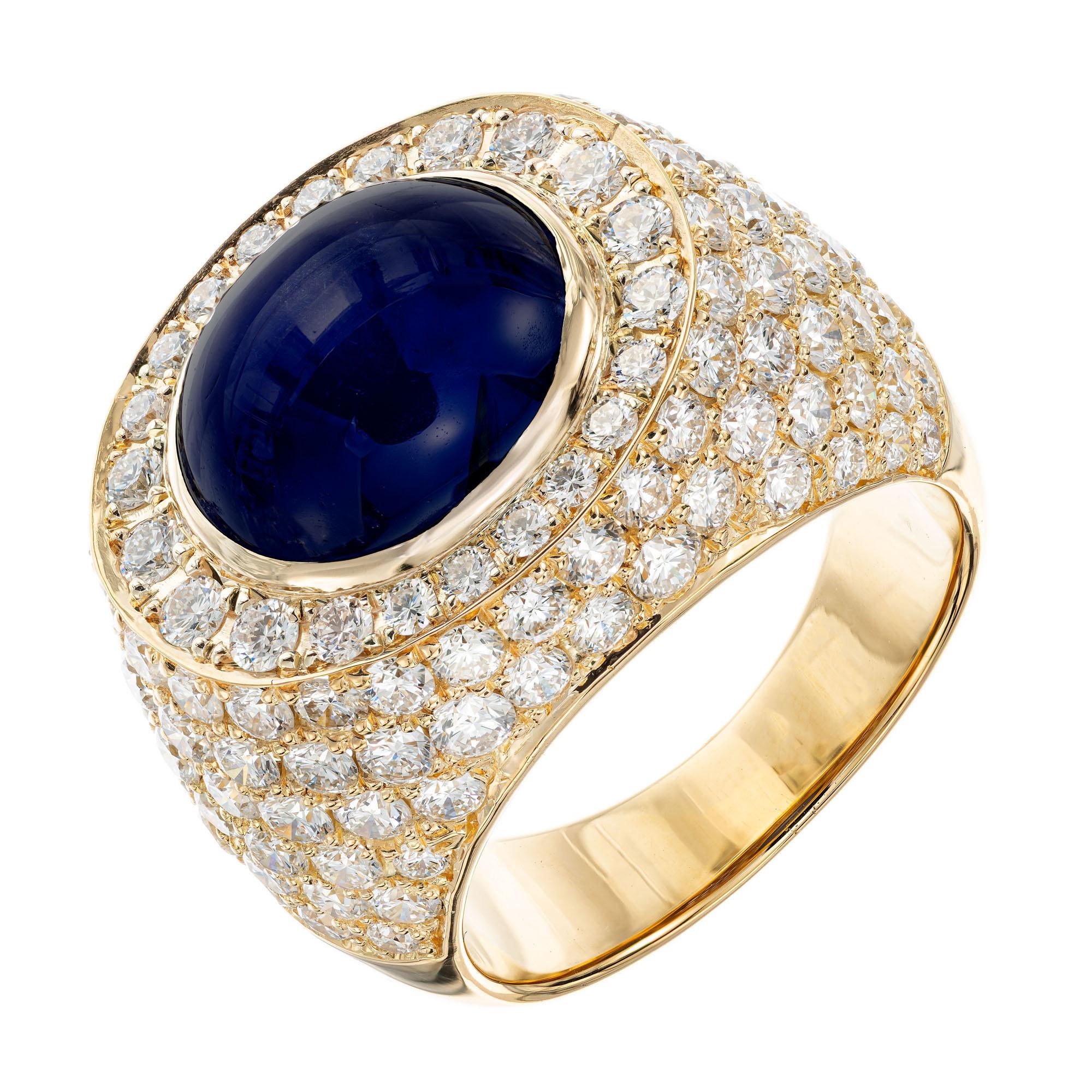 David Webb Mid-Century sapphire and diamond cocktail ring. GIA certified 14.4 carat oval cabochon Sri Lanka Sapphire center stone with 134 round brilliant cut accent diamonds. 18k yellow gold cocktail setting. This beautiful rich blue sapphire is