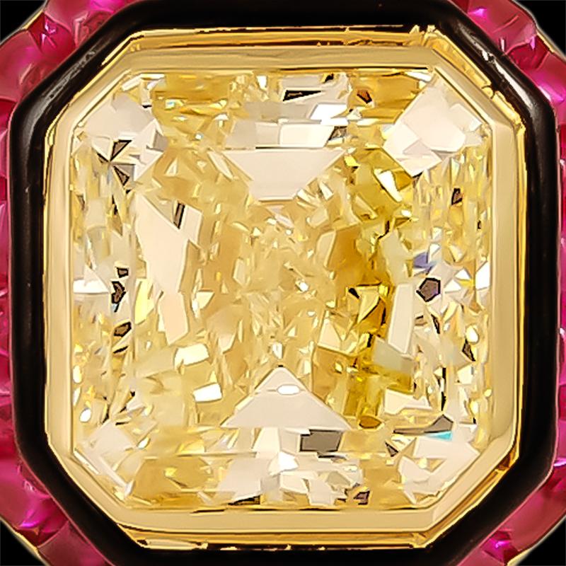A David Webb yellow diamond and ruby ring, set in 18k gold with a cut-cornered square-cut natural fancy yellow diamond, surrounded by a band of black enamel and a band of cabochon rubies. The diamond weighs approximately 15.08 carats and a clarity