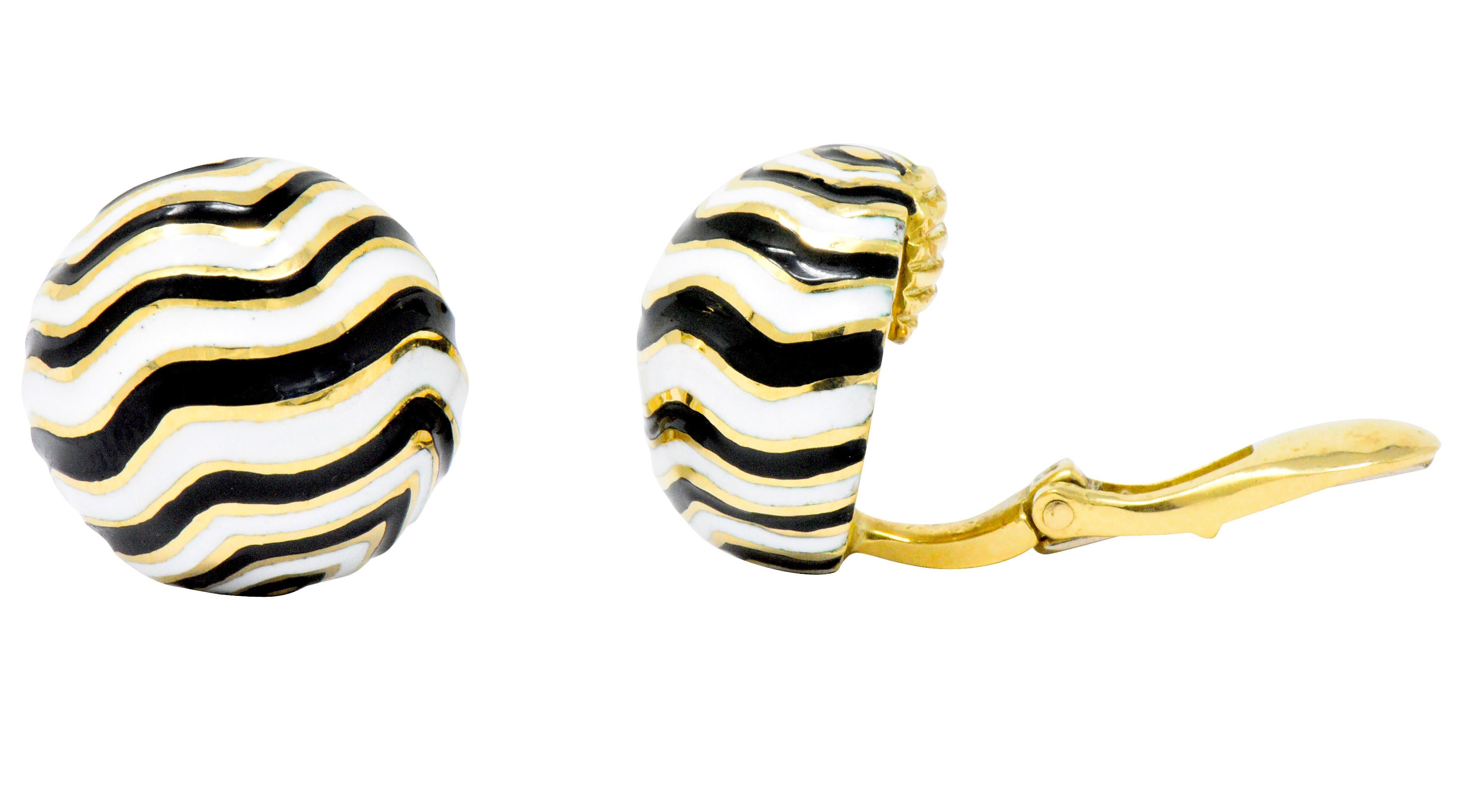 Featuring bold black and white striated enamel on round domed yellow gold surface

Striations resemble the coloring of a zebra

From the Kingdom Collection circa 1960

Hinged ear clips with secure tension

Measuring 14 mm x 15 mm x 8 mm deep

Total