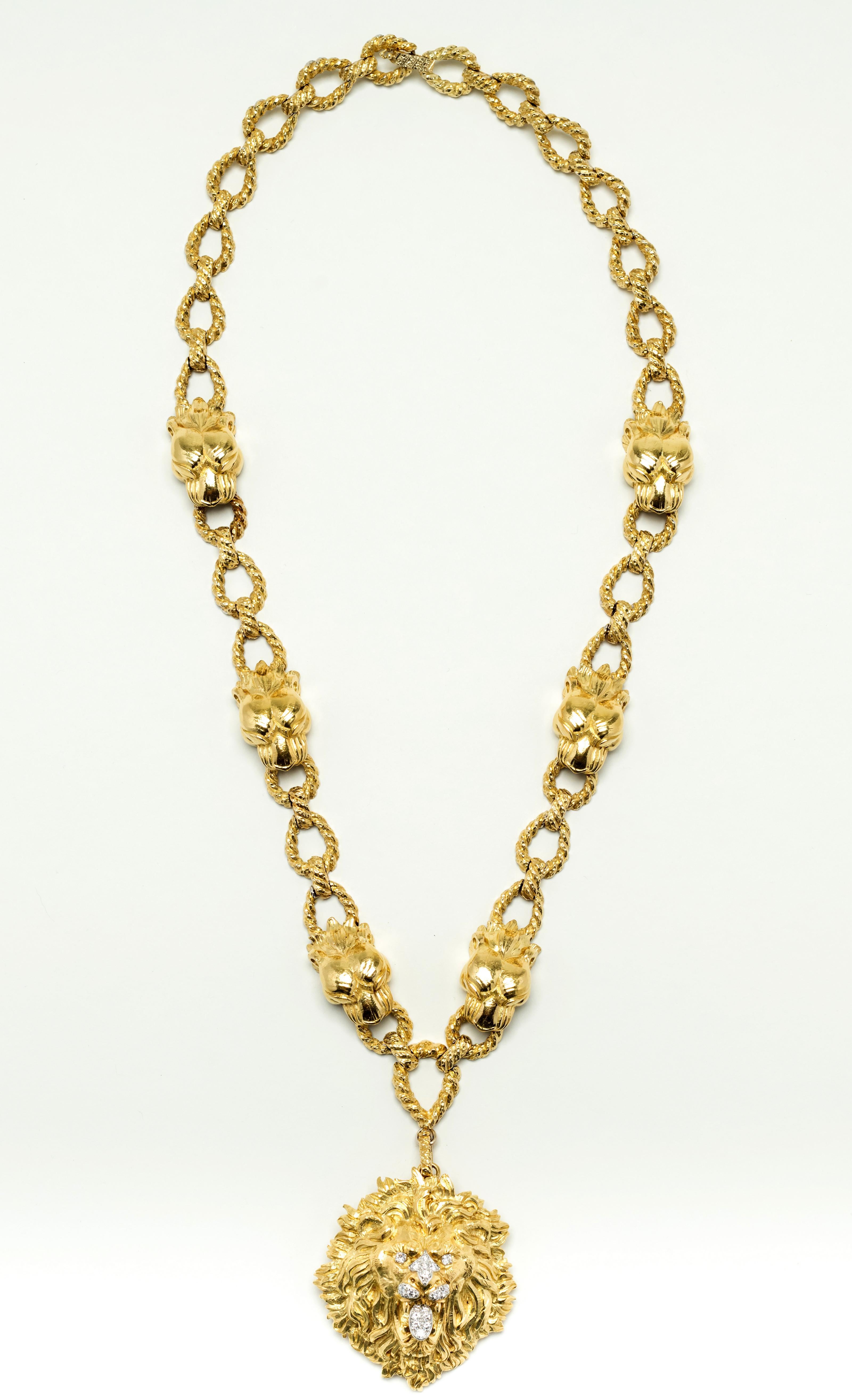 Magnificent 18 Karat gold signed David Webb necklace with detachable lion head pendant. The necklace consists of large rope style figured links interspersed with lion heads. The bottom link has a detachable clasp that supports a highly detailed lion