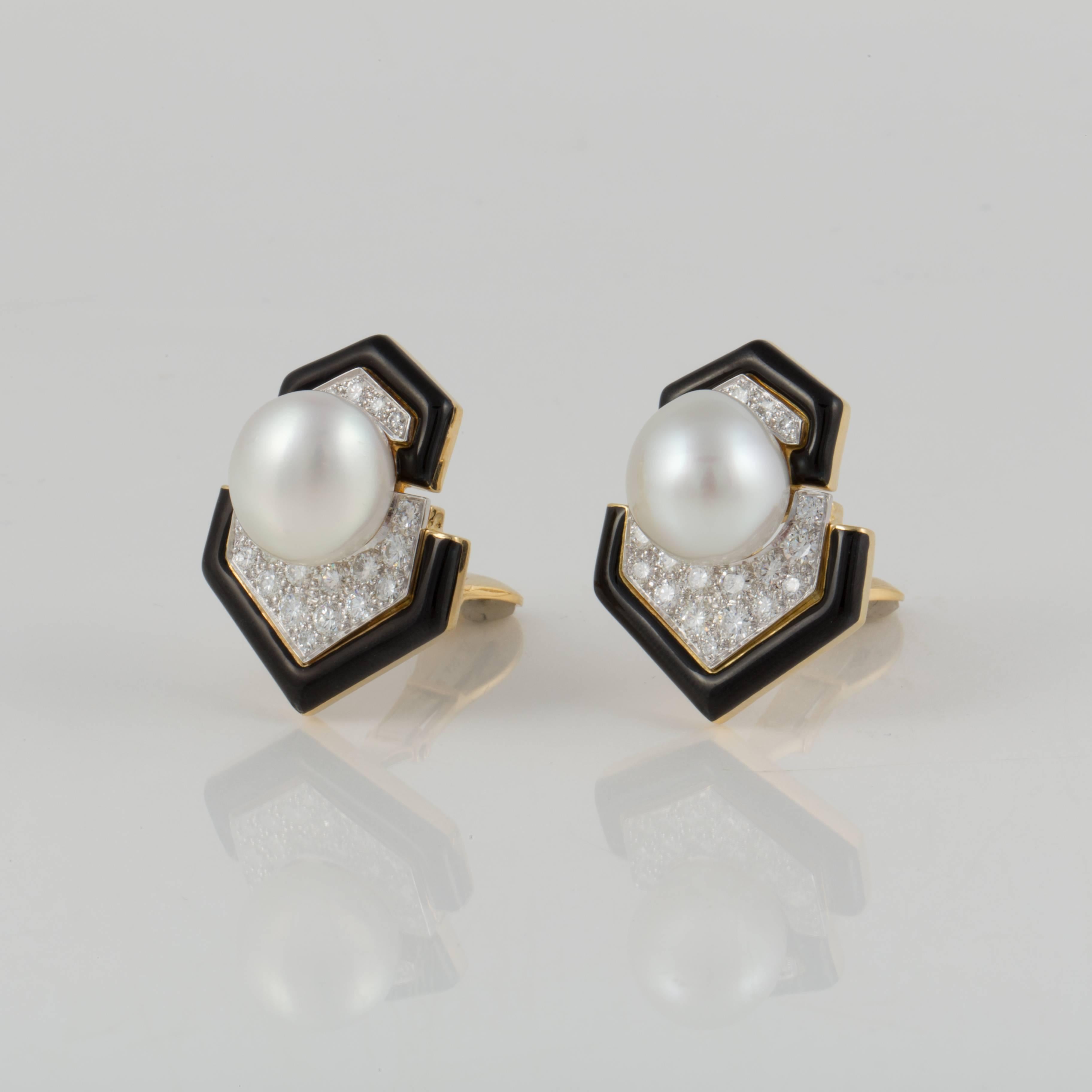 David Webb earrings composed of 18K yellow gold, black enamel, pearls and diamonds set in platinum.  These classic earrings are marked 