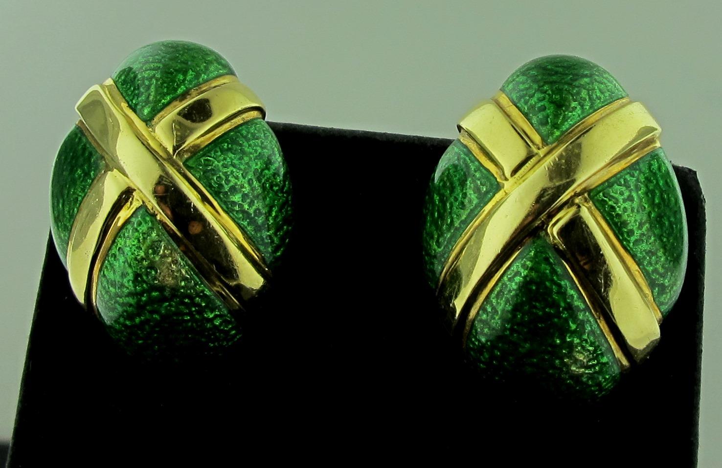 Signed David Webb oval shaped earrings in 18 karat yellow gold highlighted with green enamel.  Gold weight is 28 grams.