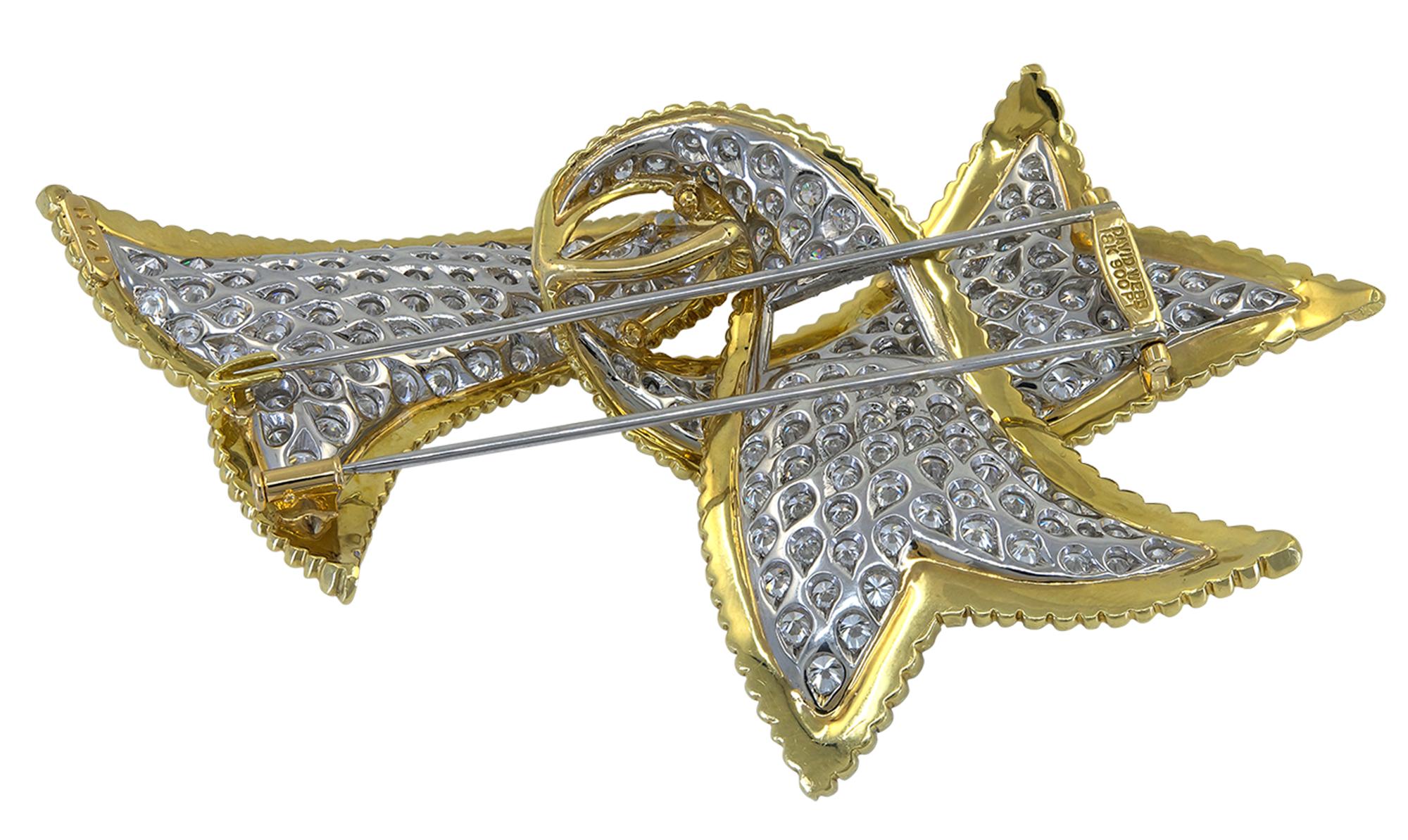 Elegant ribbon brooch created by David Webb featuring approximately 14.74 carats of brilliant-cut diamonds, textured 18K yellow gold, and platinum.
Signed David Webb.
Certificate of Authenticity is provided.