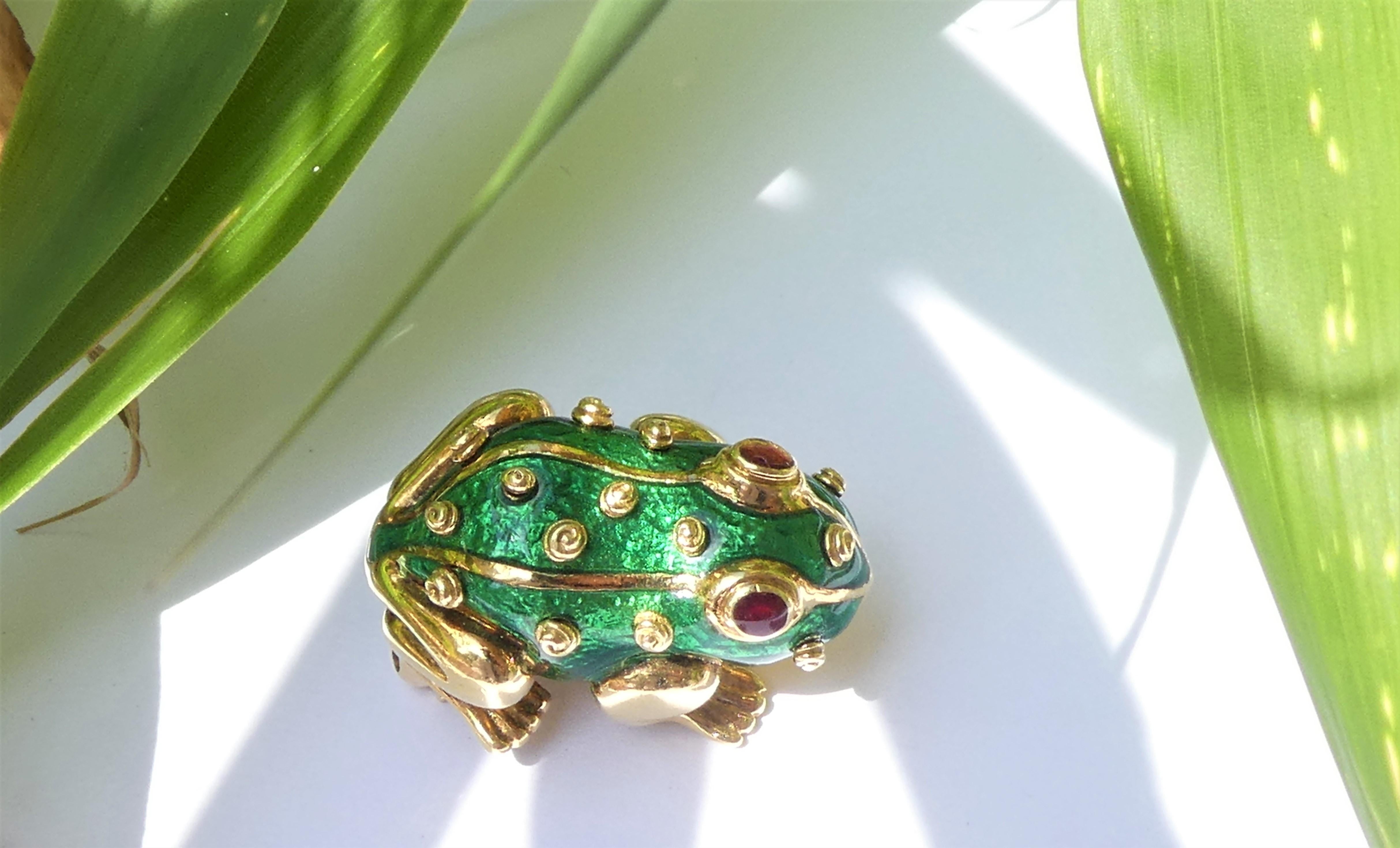 Frog Brooch of the 1970s by David Webb. It is crafted in 18 karat yellow gold with green enamel. The eyes are in red enamel. The brooch is stamped Webb and 18 karat. There are two more stamps: the letters C and R. I particularly like the 14 little