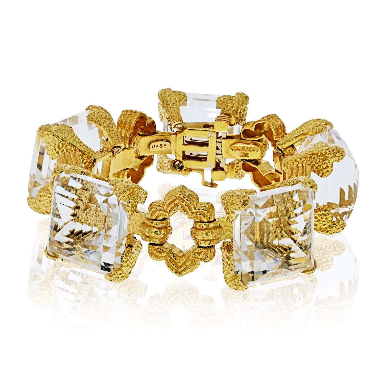 David Webb 18K Yellow Gold and Rock Crystal Open-Link Bracelet.

A striking bracelet by David Webb, crafted in 18K yellow gold and set with bold faceted rock crystal links. Measuring 7 inches when laid flat, it is ideal for wrists approximately 6.25