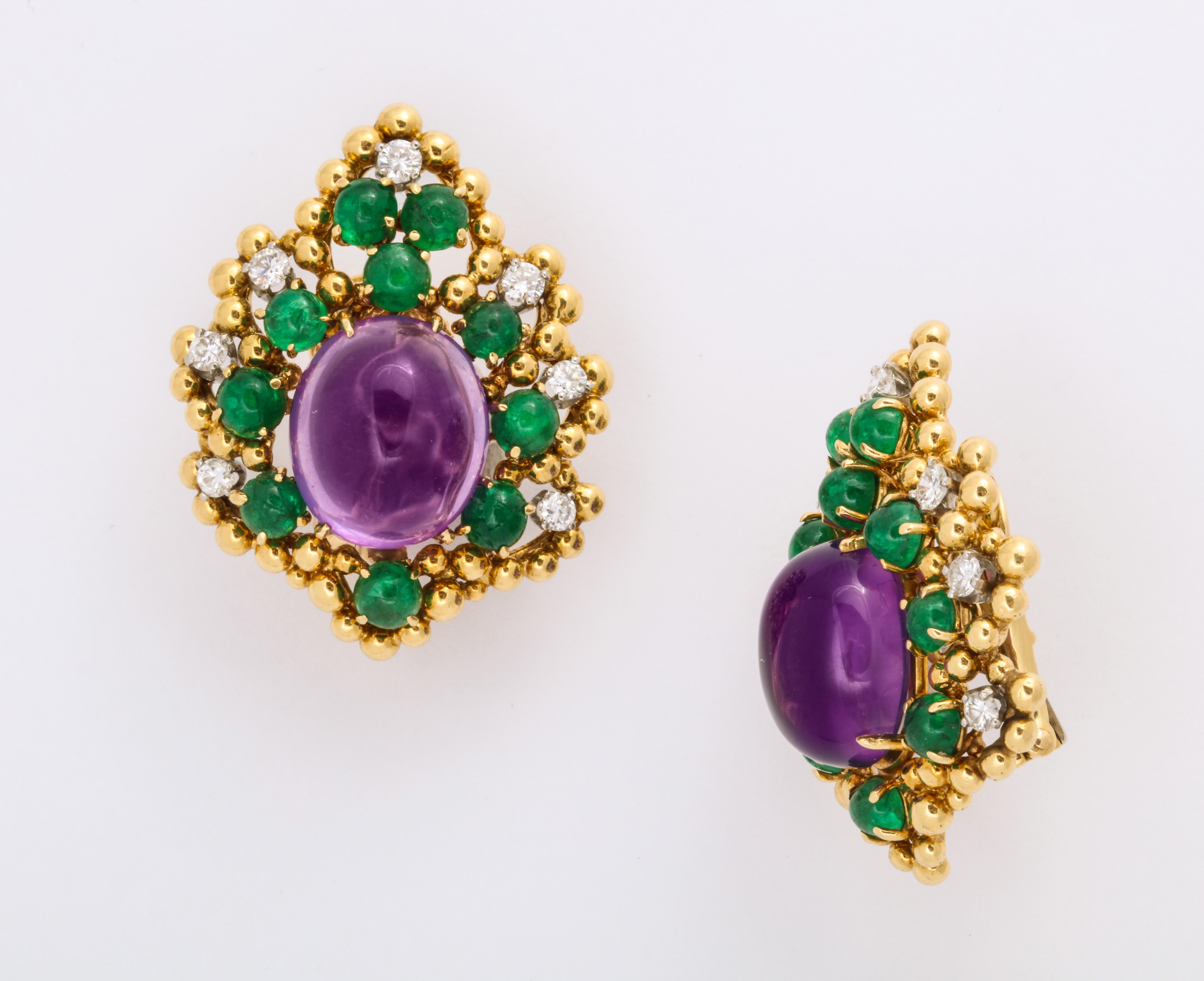 These wonderful 18K yellow clip-on gold earrings are a classic color combination of amethyst and emerald, with a diamond accent on the border.  Signed by David Webb, and most probably made c1975.  The diamonds are estimated to be just under 1 carat