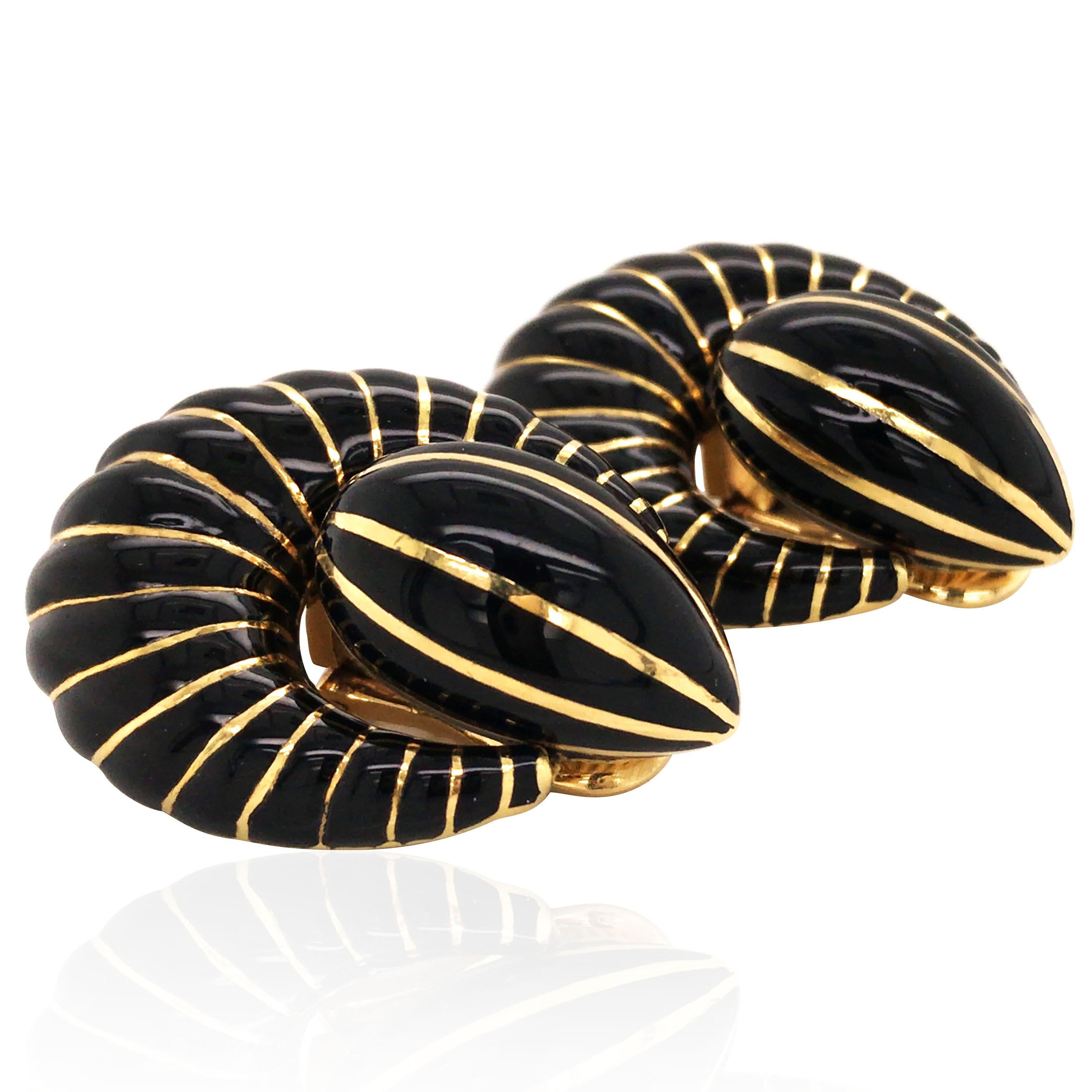 In the shape of door-knocker. With black enamel stripes, outlined in gold. Clip backs.  Stamp: 