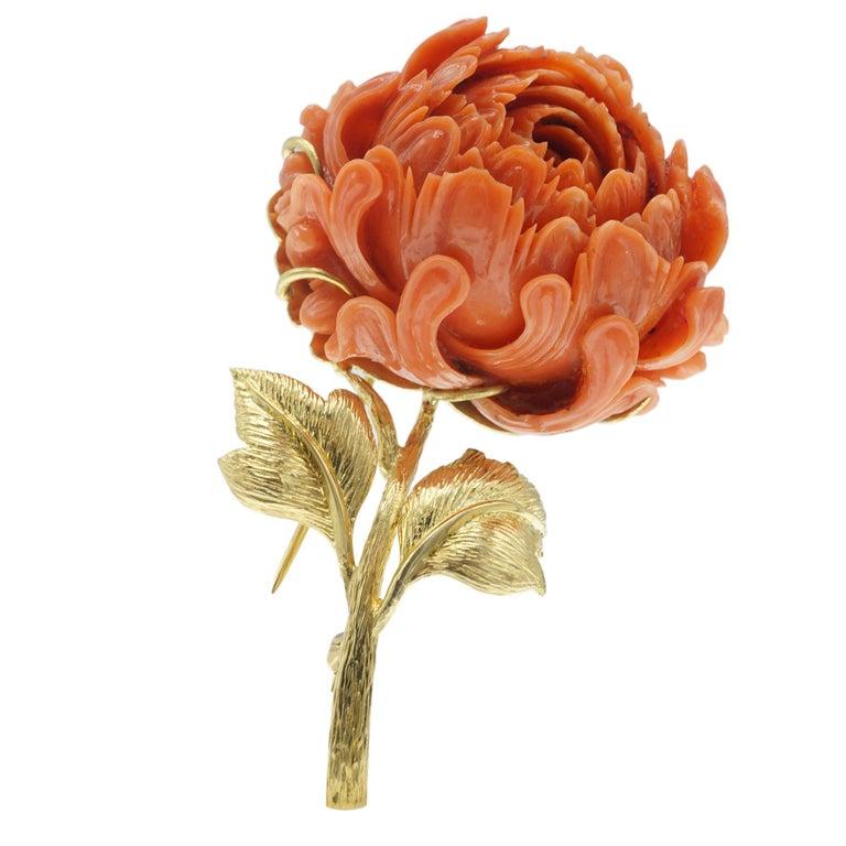 Leaves and stem is crafted in 18 karat gold featuring coral carved flower. Double stem pin and catch. Brooch dimensions L 3