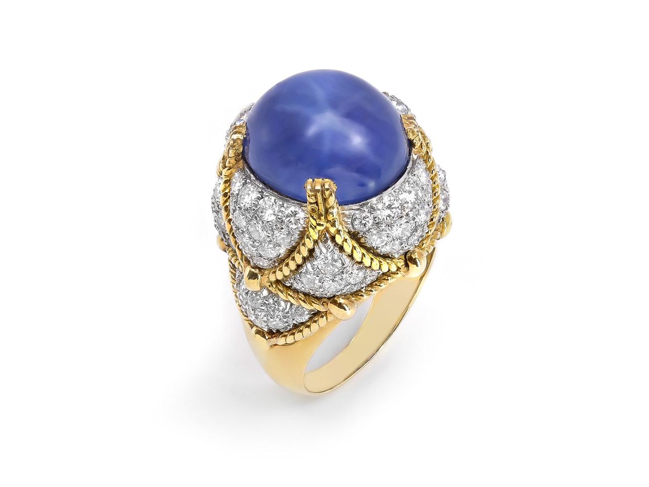 A striking domed ring by David Webb, set with an impressive 20.84-carat oval cabochon star sapphire of Sri Lankan origin, exhibiting a mesmerizing six-rayed star. The sapphire, certified no heat treatment by both GIA and AGL, is bezel-set within a
