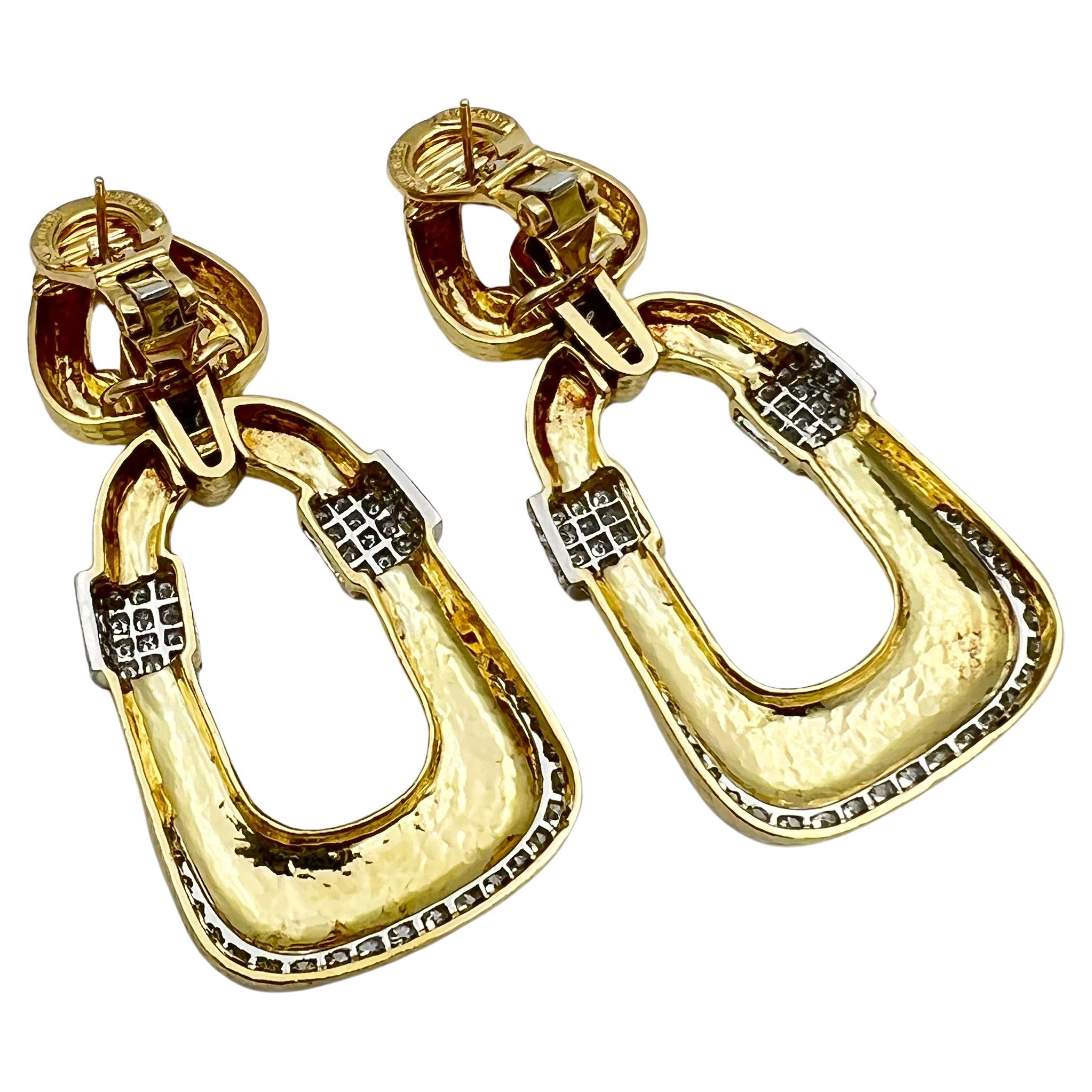 Stylish door knocker earrings by David Webb in 18 karat yellow gold, platinum and diamonds.  Hammered polished finish on open-work triangular design tops with tapered rectangular drop bottoms.  Joined by platinum diamond pave' links with platinum