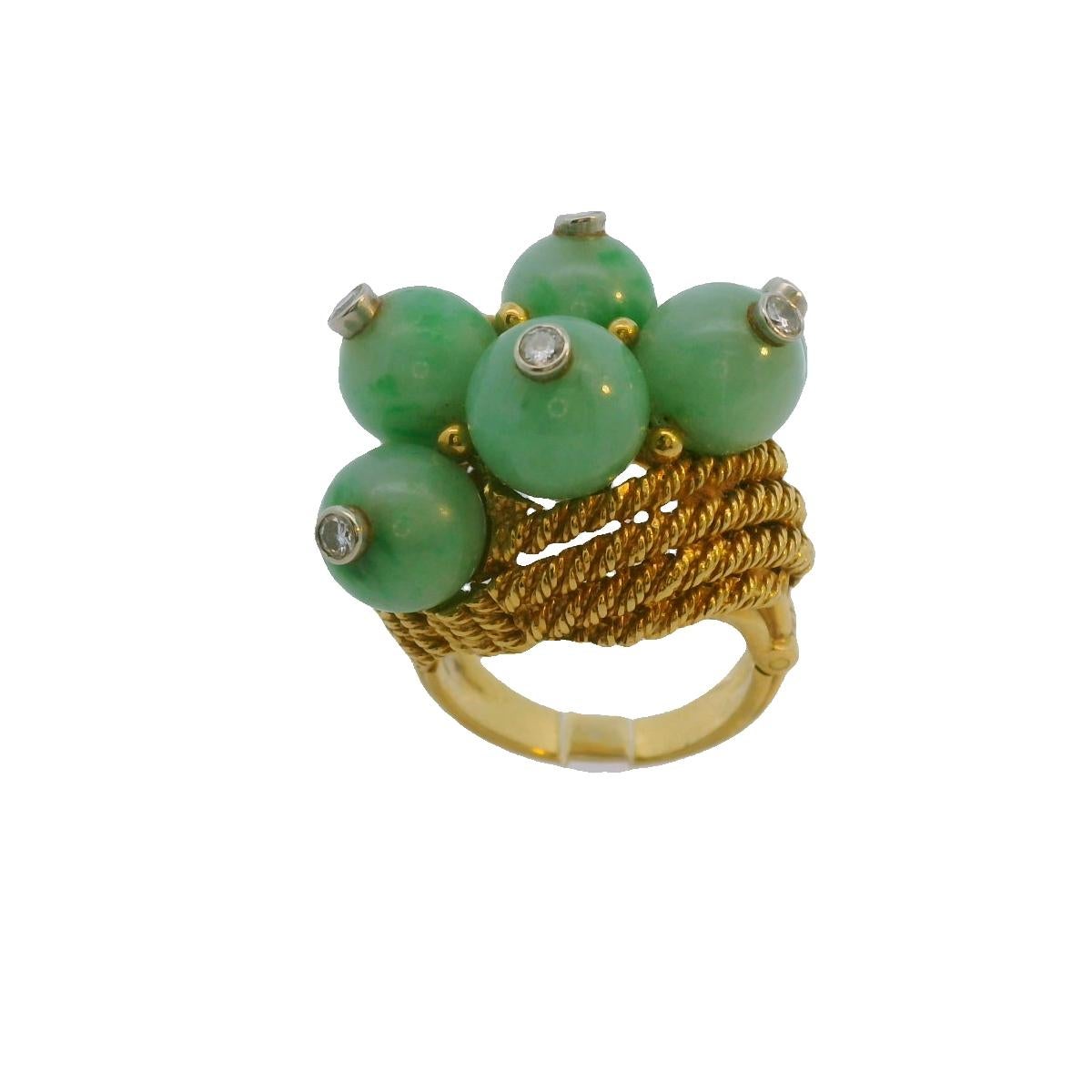 This striking David Webb cocktail ring is crafted from 18k gold and features vibrant green jade spheres accented by white diamonds. Weighing 22.47 grams and sized at 7.5, it showcases a bold design and exquisite craftsmanship, making it a standout