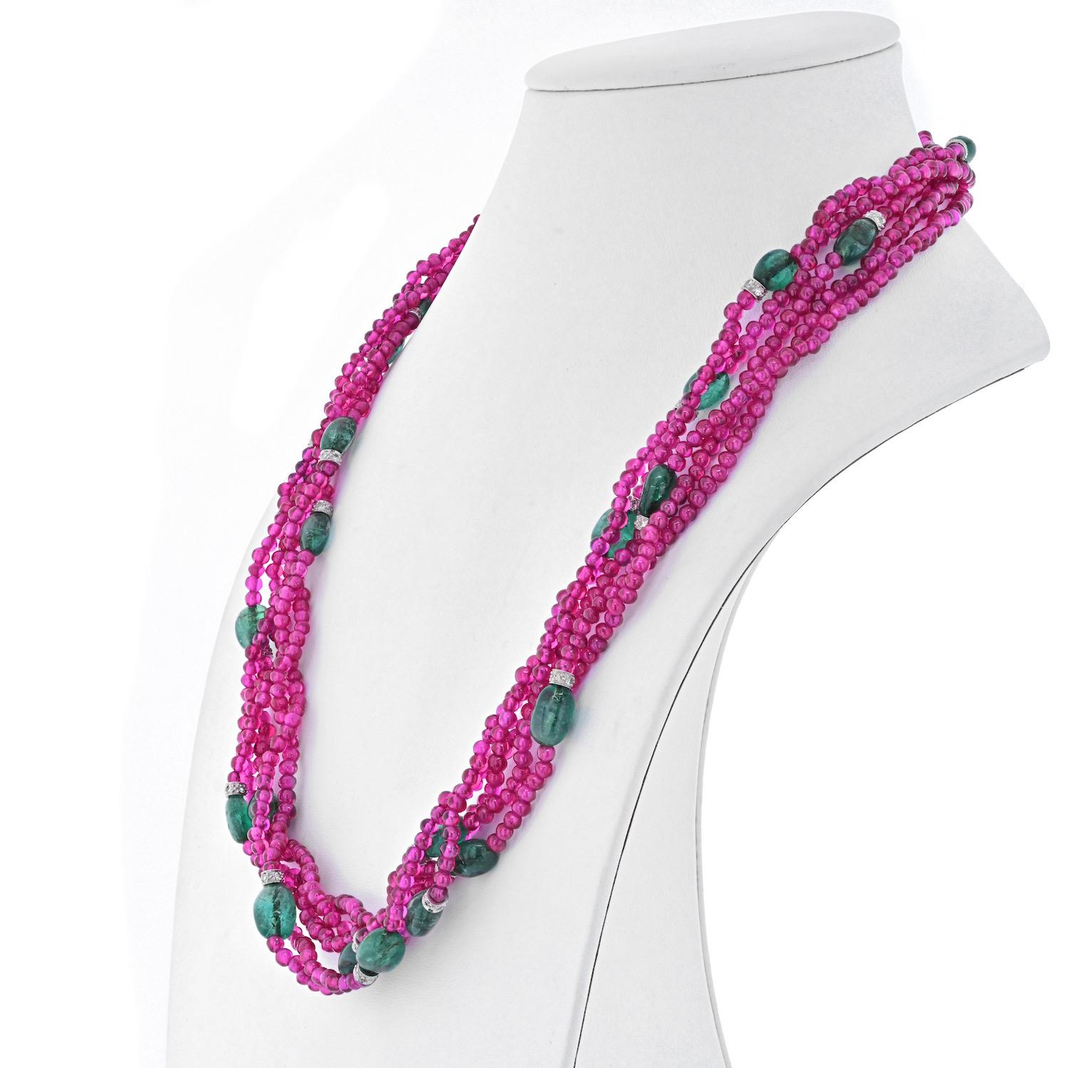 This is an exciting and fun five strand ruby necklace by David Webb. It is designed as 5 strands of ruby beads, and polished cabochon sapphires spaced evenly across the length, with round diamonds on white gold caps. Length: 20 inches.
