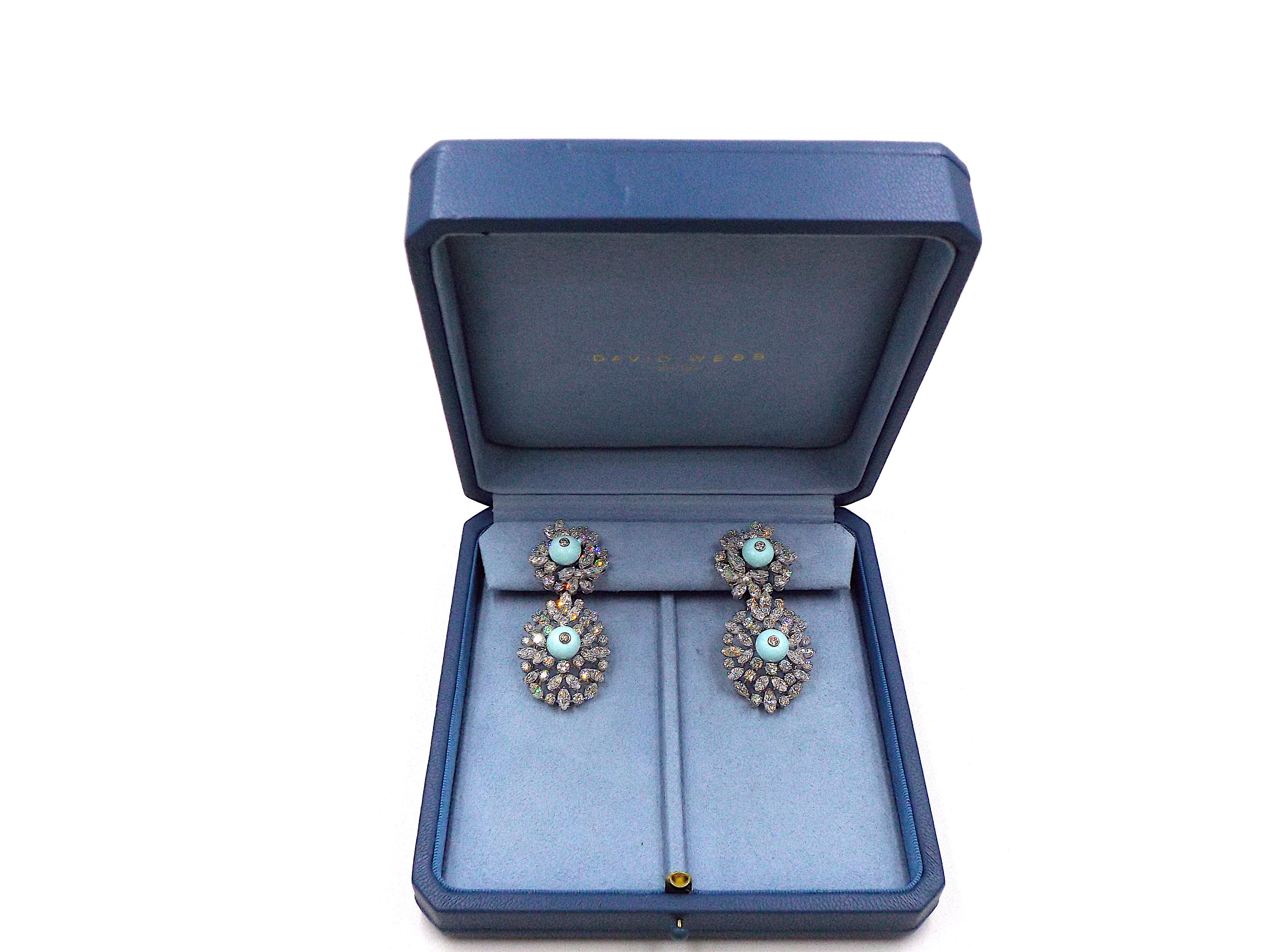 A pair of astonishing turquoise and diamond earrings by David Webb. Mount in 18K white gold and platinum, centering four cabochon turquoise stones surrounded by 124 diamonds weighing 27 carats. Each earring weighs 27.5 grams, dimensions 2.5