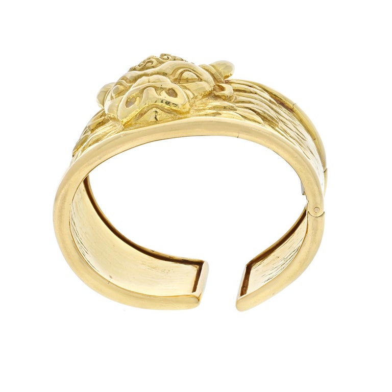 A vintage classic with timeless appeal from David Webb's Taurus collection, circa 1979. This mythology-inspired hinged cuff bracelet is made of textured and polished 18k yellow gold and features a beautifully sculpted head of the sacred bull,