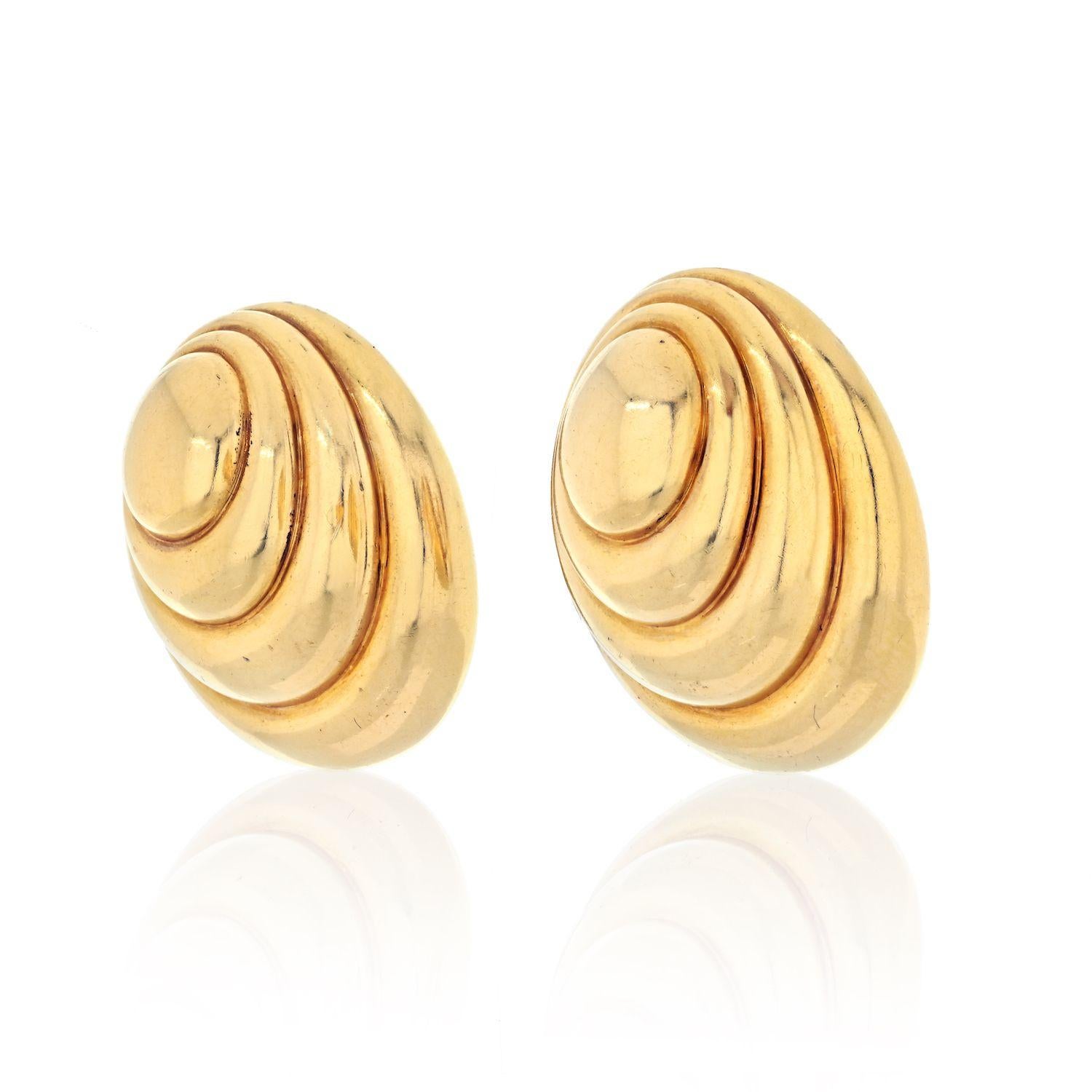 Oversized earrings is what David Webb is known for. You won't be unnoticed wearing these stricking 18k gold spiral dome earrings. High polished yellow gold has a special shine that everyone will see a mile away.  
Secured by a solid clip back, fully