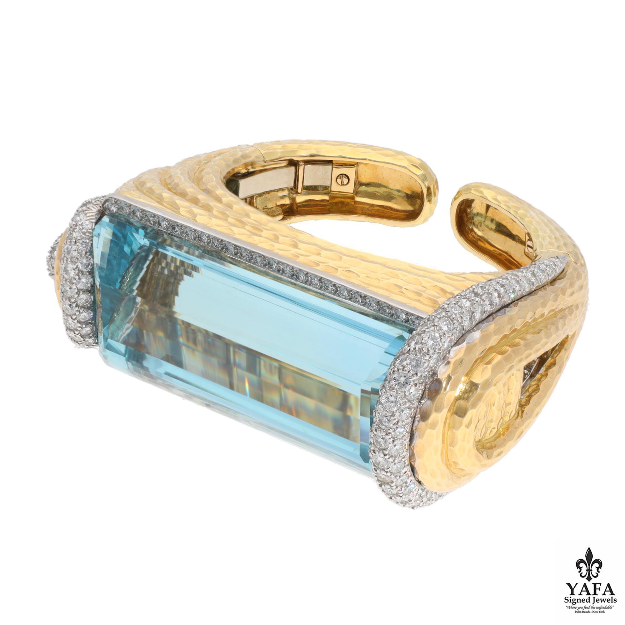 David Webb 18K Yellow Gold & Platinum, Aquamarine and Diamond Cuff. Prominently featuring a 300 CT Aquamarine. This particular Aquamarine is know for it's stunning blue-green hue so reminiscent of the ocean.  
Aquamarine approximate weight - 300