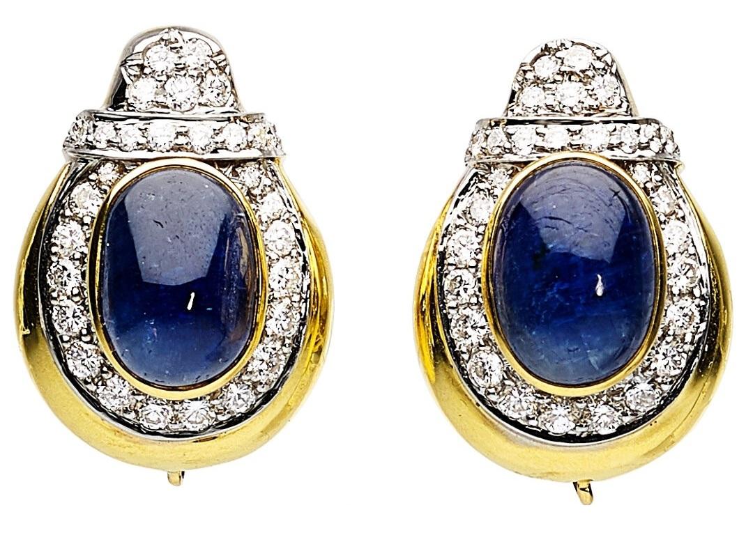 Gorgeous, Unique Clip-On Earrings by David Webb
Feature Day/Night Design with Detachable Tumbled Sapphire Bottoms
Tops Feature Oval-Shaped Cabochons Measuring 12.75 x 8.80 mm and 13.15 x 9.30 mm
Round Diamond Accents Total Weight = Appx 1.93