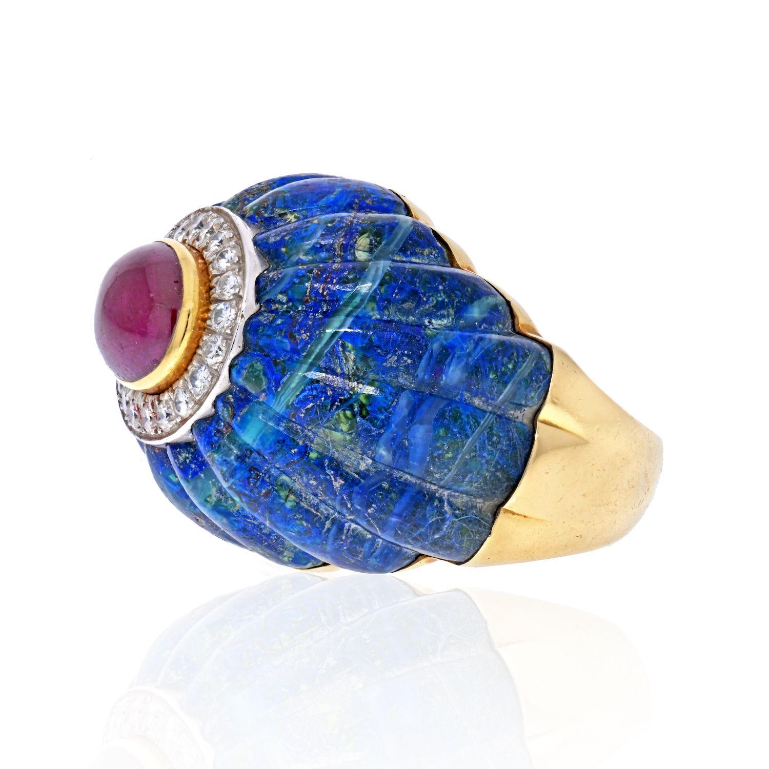 From renowned New York jewelry designer David Webb we offer the 1970s 18K gold ring of large Mellon-cut Azure-Malachite topped by a cabochon ruby surrounded by oval platinum frame-mounted with approximately .50cts of round white diamonds. 

A lively