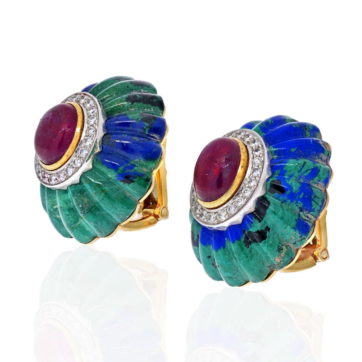 From renown New York jewelry designer David Webb we offer a pair of 1970s 18K gold ear clips of hand carved azurite-malachite set with a cabochon ruby framed in a surround of gold with platinum set diamonds. Measuring 5/8 inch x 1 inch. Maker and