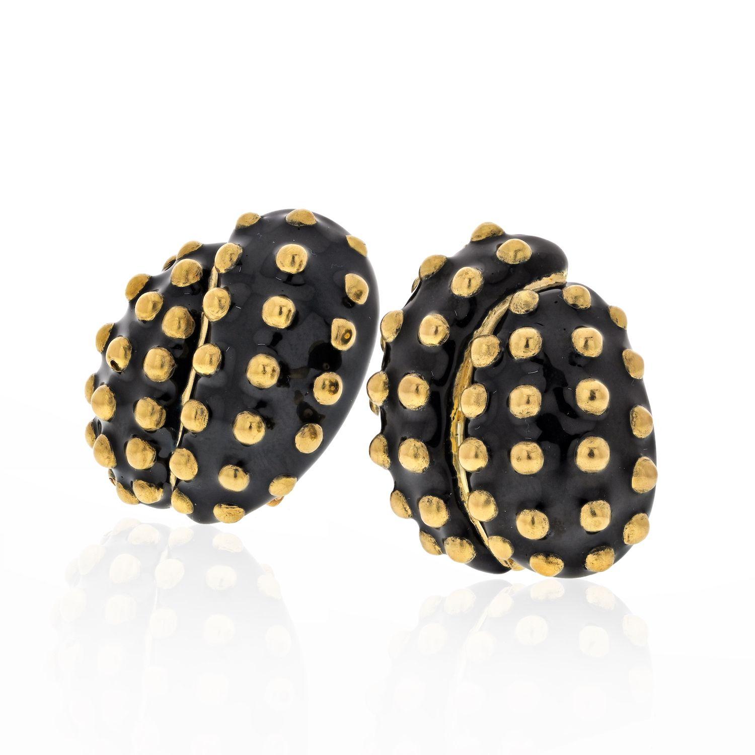 A unique pair of 18k yellow gold, black enamel, gold studded clip earrings by David Webb. The earrings feature bead bubble gold studs applied all around the surface of black enameling. The earrings measure 27mm in height and 22mm in width and have a