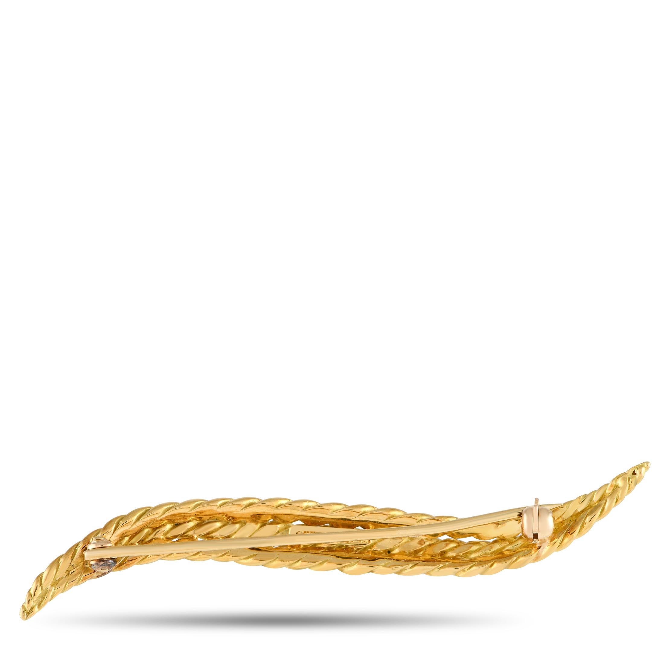 This sleek, stylish David Webb brooch is a minimalist piece with plenty of visual impact. Textured 18K Yellow Gold adds texture to this piece, which measures 2.5 long by 0.25 wide.This jewelry piece is offered in estate condition and includes a gift