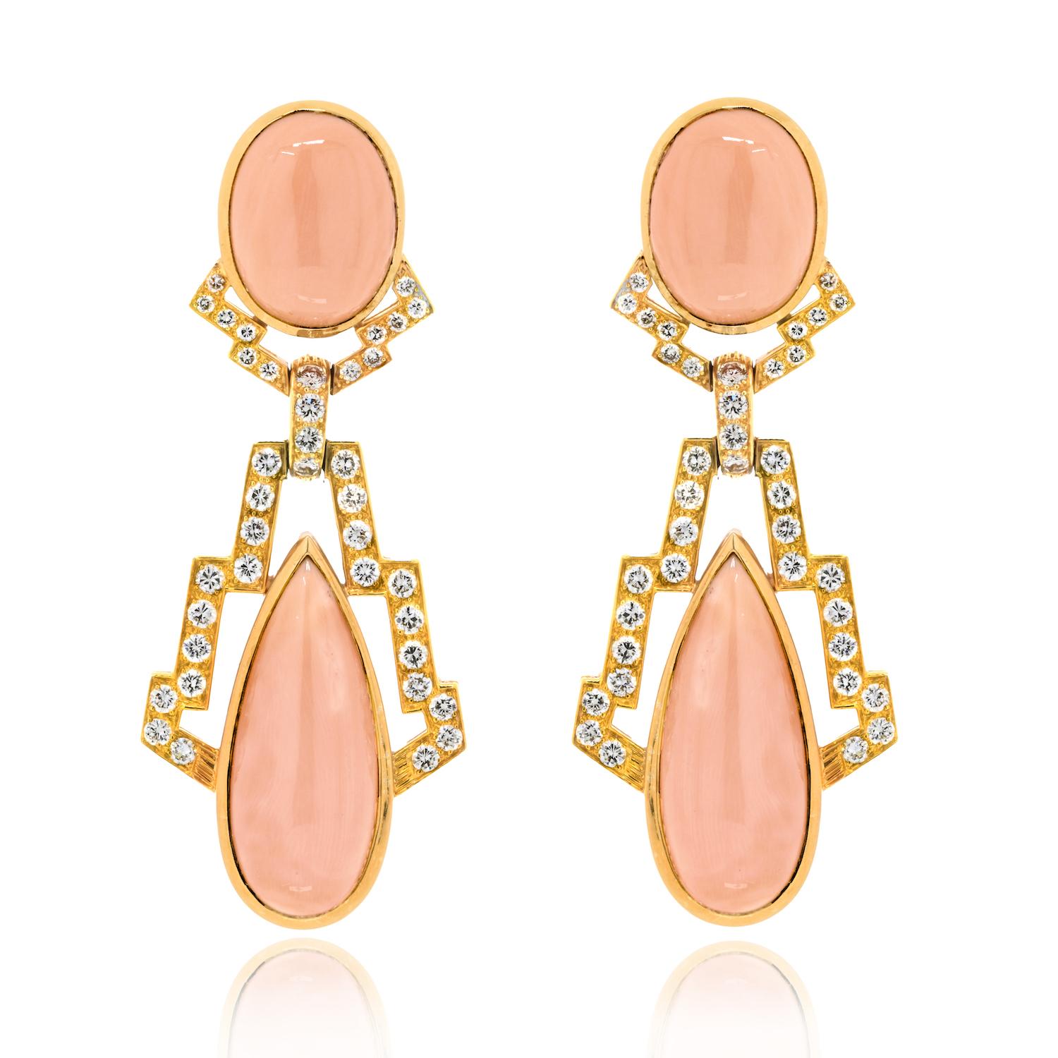 Step into a world of timeless elegance with the David Webb 18K Yellow Gold Diamond and Coral Drop Ear Clips, a mesmerizing pair designed to captivate. These ear clips, adorned with cabochon oval and pear-cut corals, are enriched with the brilliance