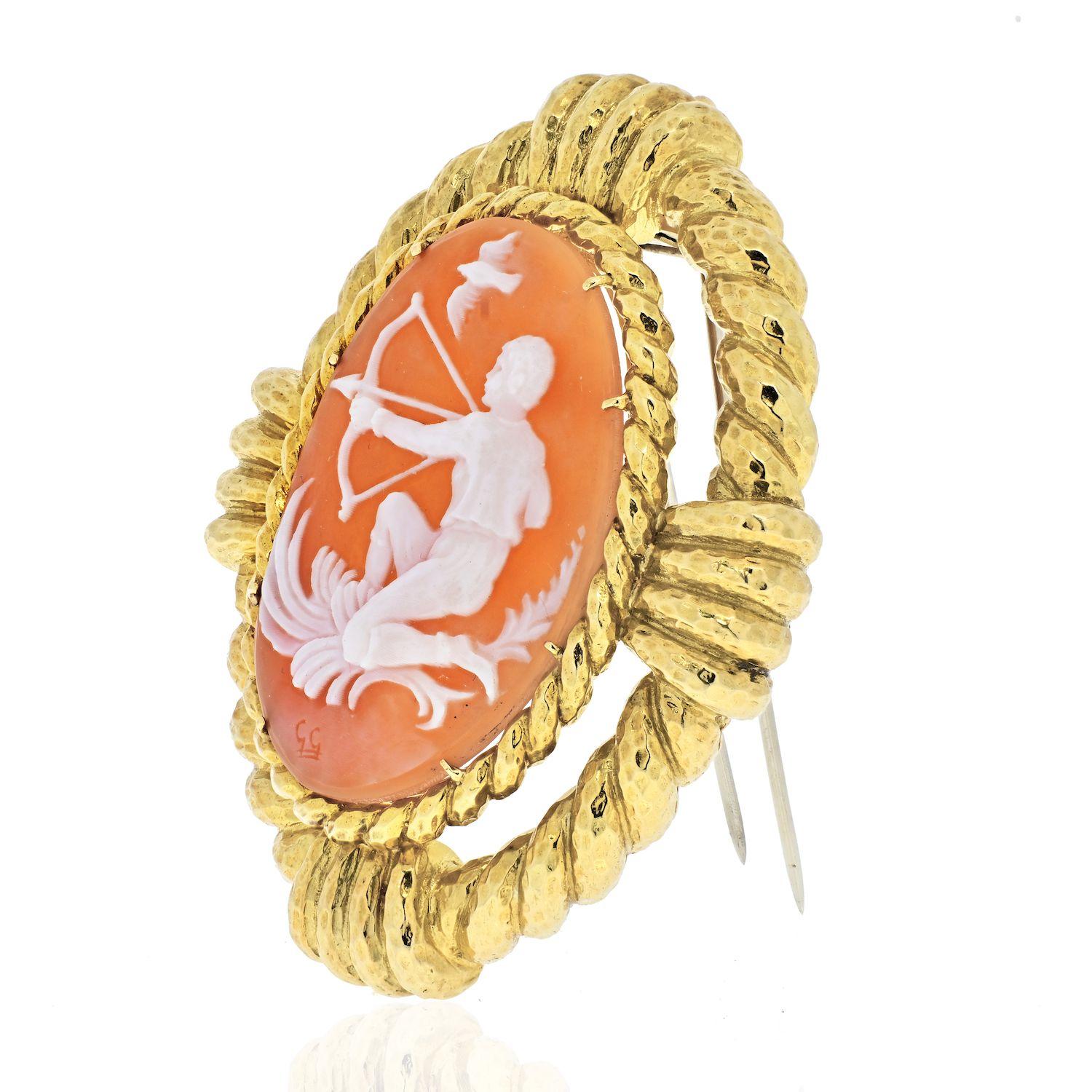 The shell cameo depicting Sagittarius, with a hammered gold frame
18k yellow gold
Signed Webb
2 1/2 x 2 ins; Gross weight 35.9 dwts
Can be worn as a pin and as a pendant.
