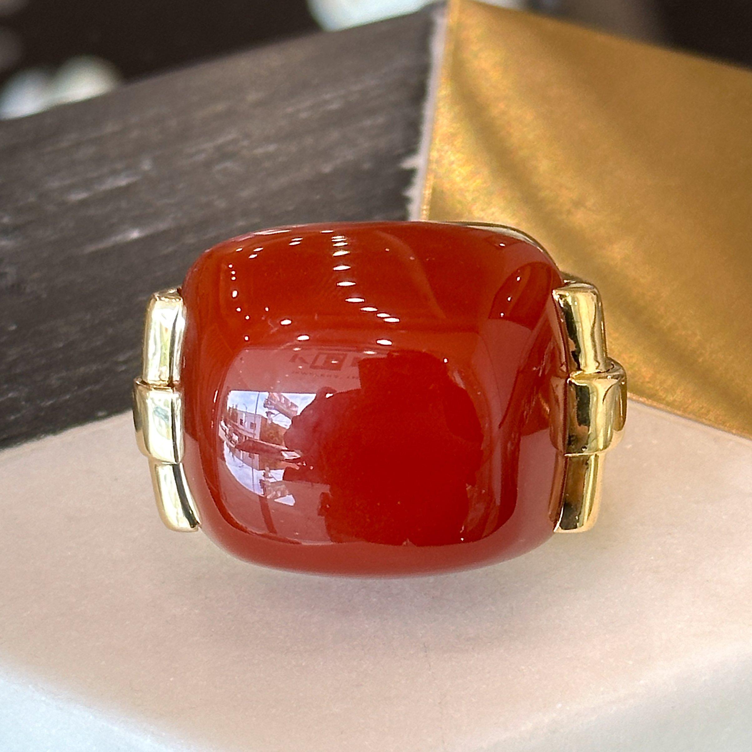 This vintage David Webb carnelian cabochon cocktail rings dates from the 1960’s and is crafted in 18KT yellow gold. The top of the ring measures 36mm x 26mm and its profile sits 38mm high. The ring is a size 5 with an adjustable ring guard inside.