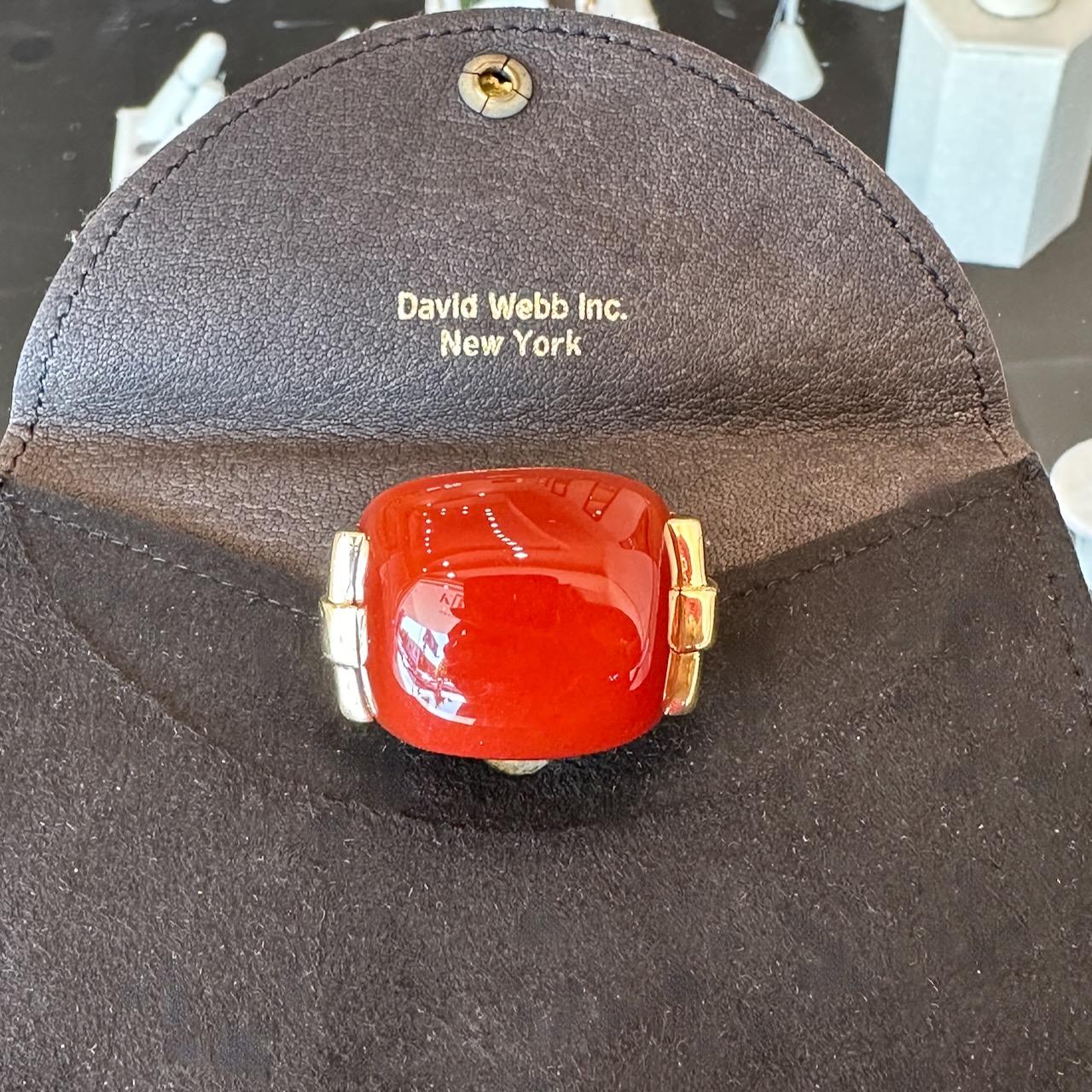 This vintage David Webb carnelian cabochon cocktail rings dates from the 1960’s and is crafted in 18KT yellow gold. The top of the ring measures 36mm x 26mm and its profile sits 38mm high. The ring is a size 5 with an adjustable ring guard inside.