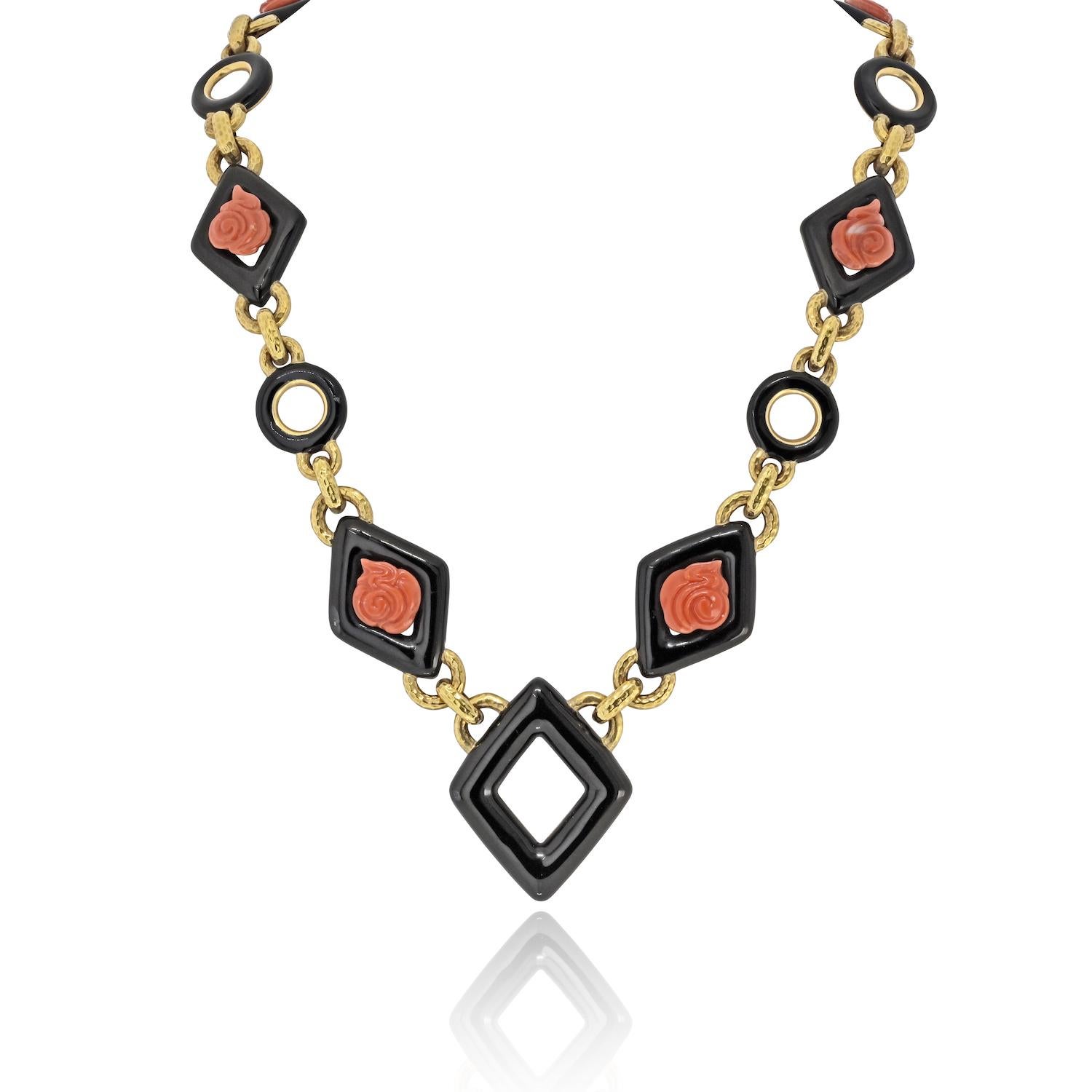 A bold and luxurious creation by David Webb, this 28-inch necklace exemplifies the designer’s masterful blend of graphic structure and organic elegance. Alternating links of 18K yellow gold, glossy black enamel, and richly hued coral roses create a
