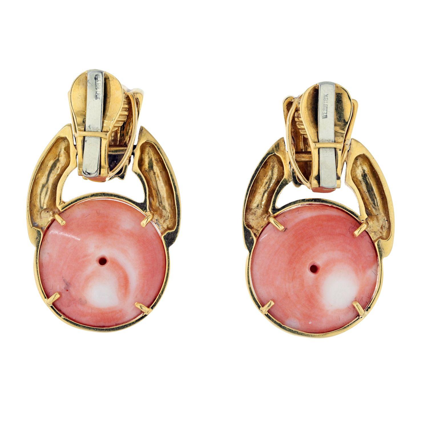 A remarkable pair of David Webb 18k Yellow Gold Estate Coral Earrings, an exquisite testament to the designer's artistic vision and timeless craftsmanship. These earrings showcase a striking door knocker design, combining the warmth of 18k yellow