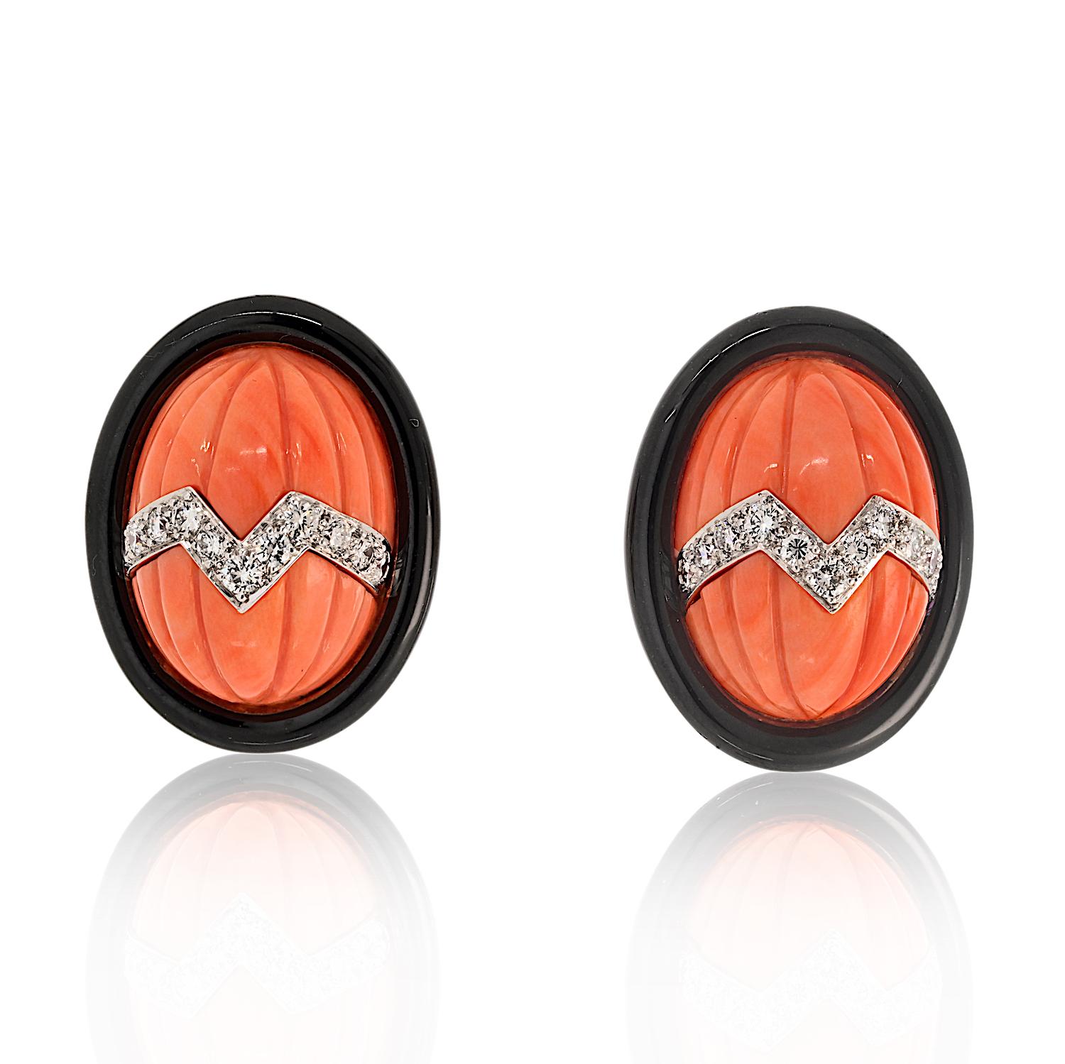These exquisite David Webb estate earrings showcase the designer’s signature bold aesthetic and masterful craftsmanship. 

At the center, a striking carved oval dome coral serves as the focal point, beautifully framed by a sleek black onyx rim for a