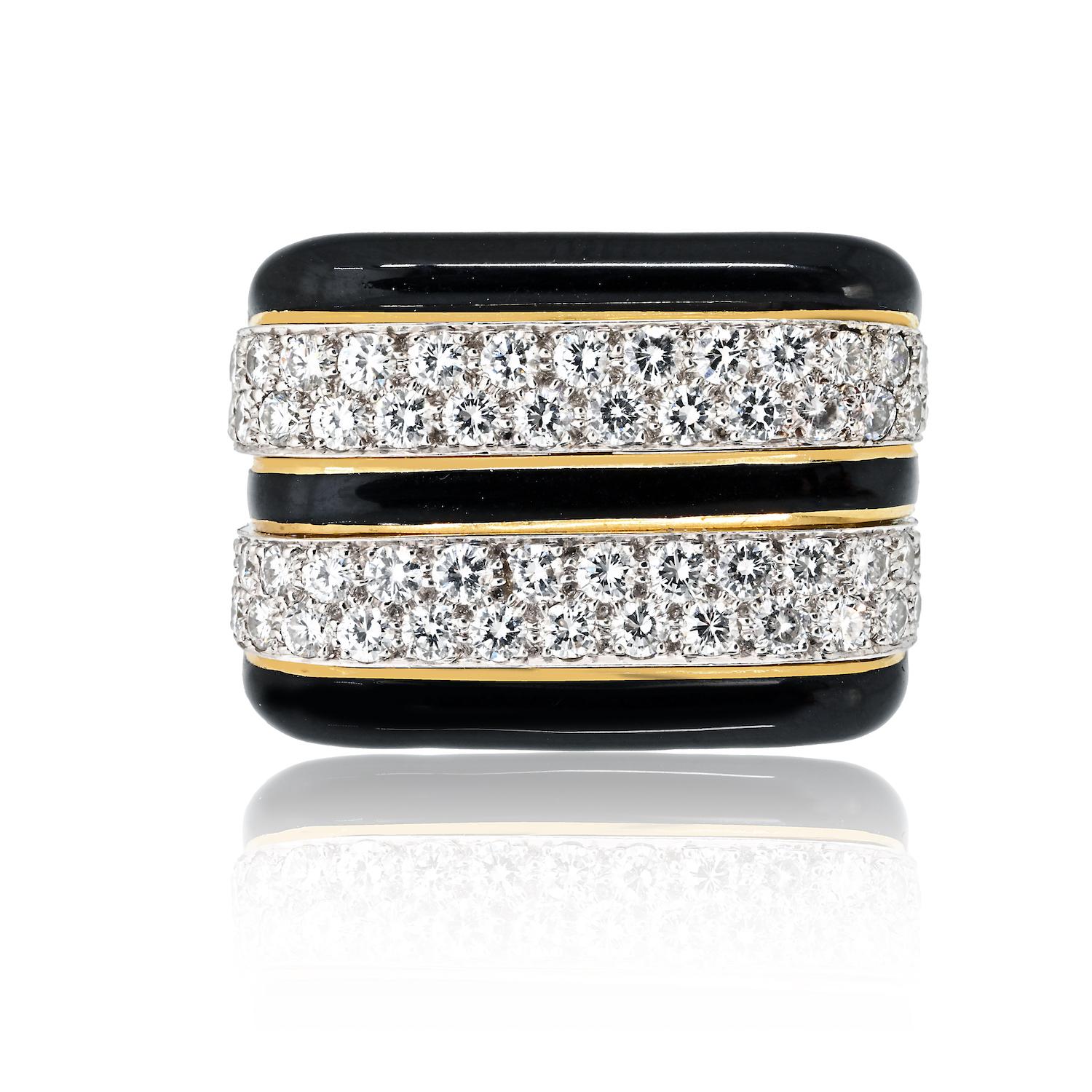 This estate David Webb ring is crafted in 18K yellow gold, featuring a bold and sophisticated design. The surface is finished with rich black enamel, creating a striking contrast against the two rows of meticulously pave-set diamonds. The wide band