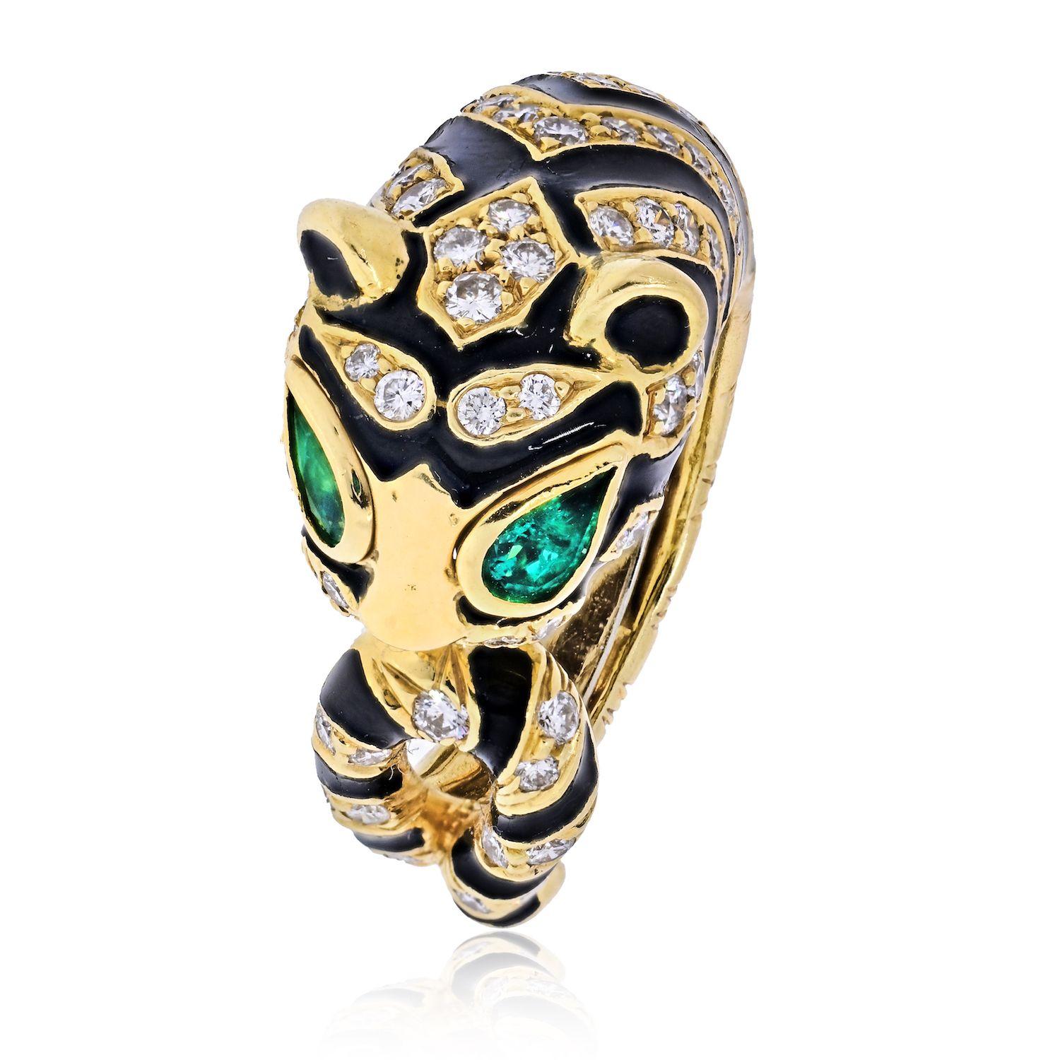 This stunning ring by David Webb crafted as the coiled tiger with looped tail. There are an estimated 1.80ctw F-G/VS in round brilliant cut diamonds and two pear cut emeralds. It measures 12mm wide above the finger and 5mm below. The ring is in very