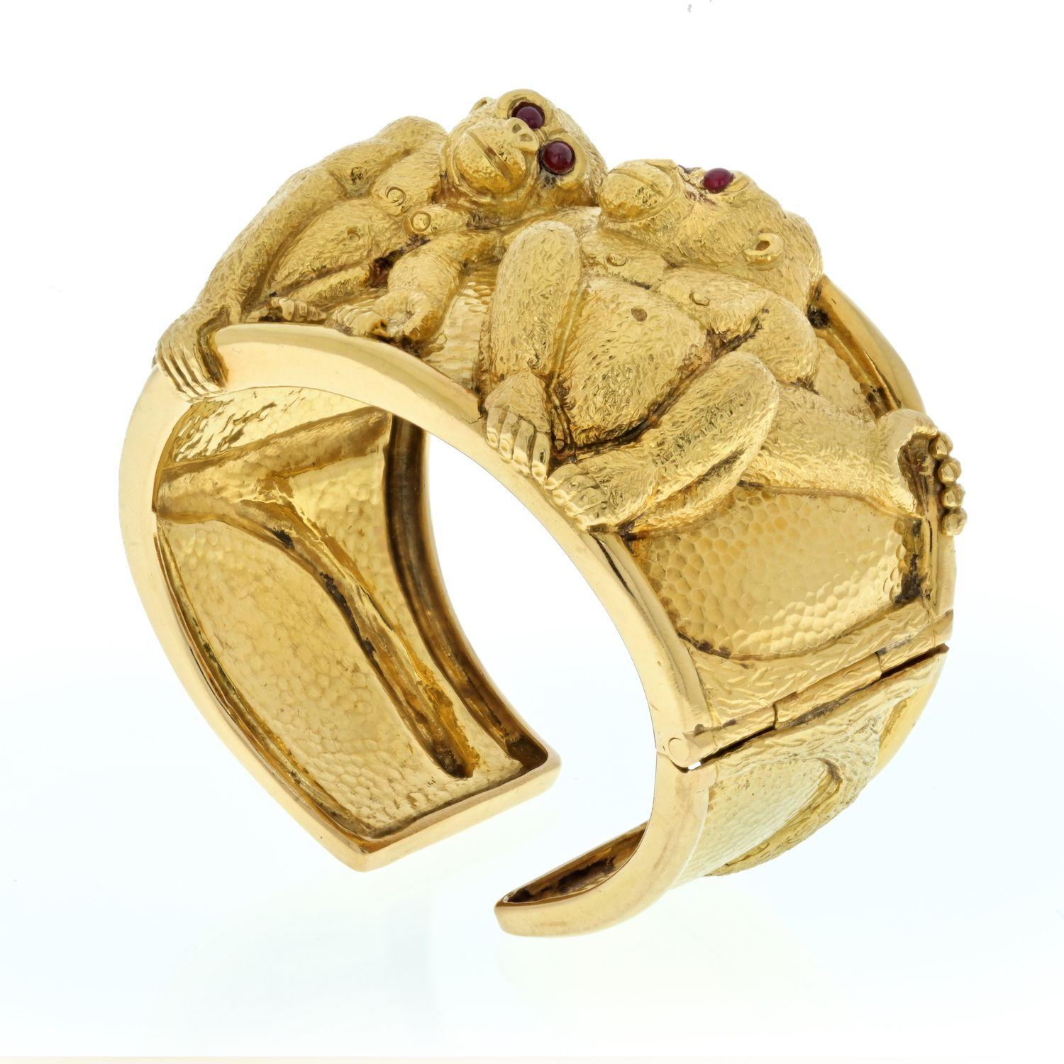 A staple piece of jewelry from David Webb is the 18K Yellow Gold Double Monkey Cuff. 
Two gorillas sit facing each other in a friendly pose, their eyes are set with cabochon rubies. 
The bracelet is a solid 18k gold cuff and will fit approx. 6.5 to