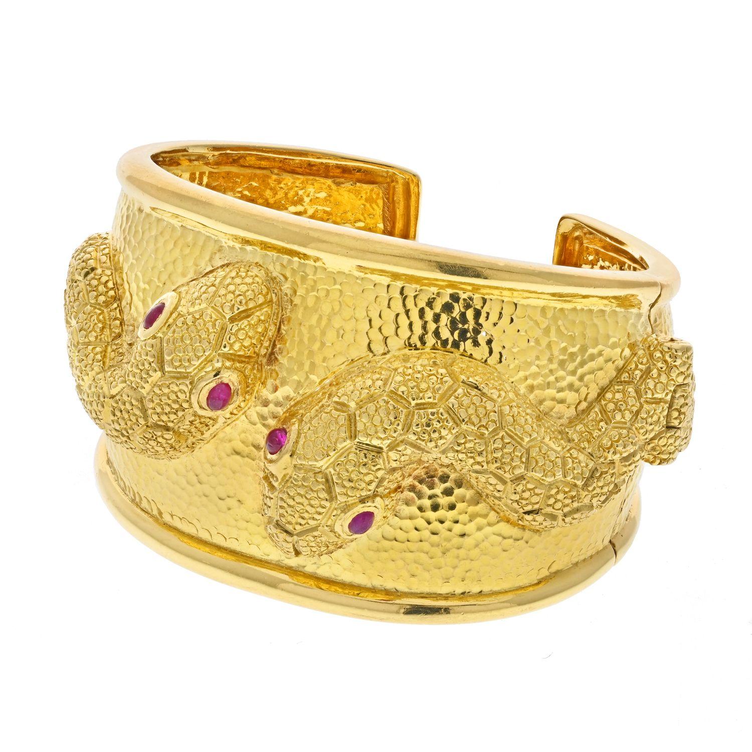 David Webb 18K Yellow Gold Twin Serpent Cuff Bracelet. 
From Kingdom Collection Twin Serpent Cuff Bracelet by David Webb, crafted in 18k yellow gold and set with cabochon rubies for eyes. Width from 40mm to 23mm. Wrist size 6.5 inches. 

