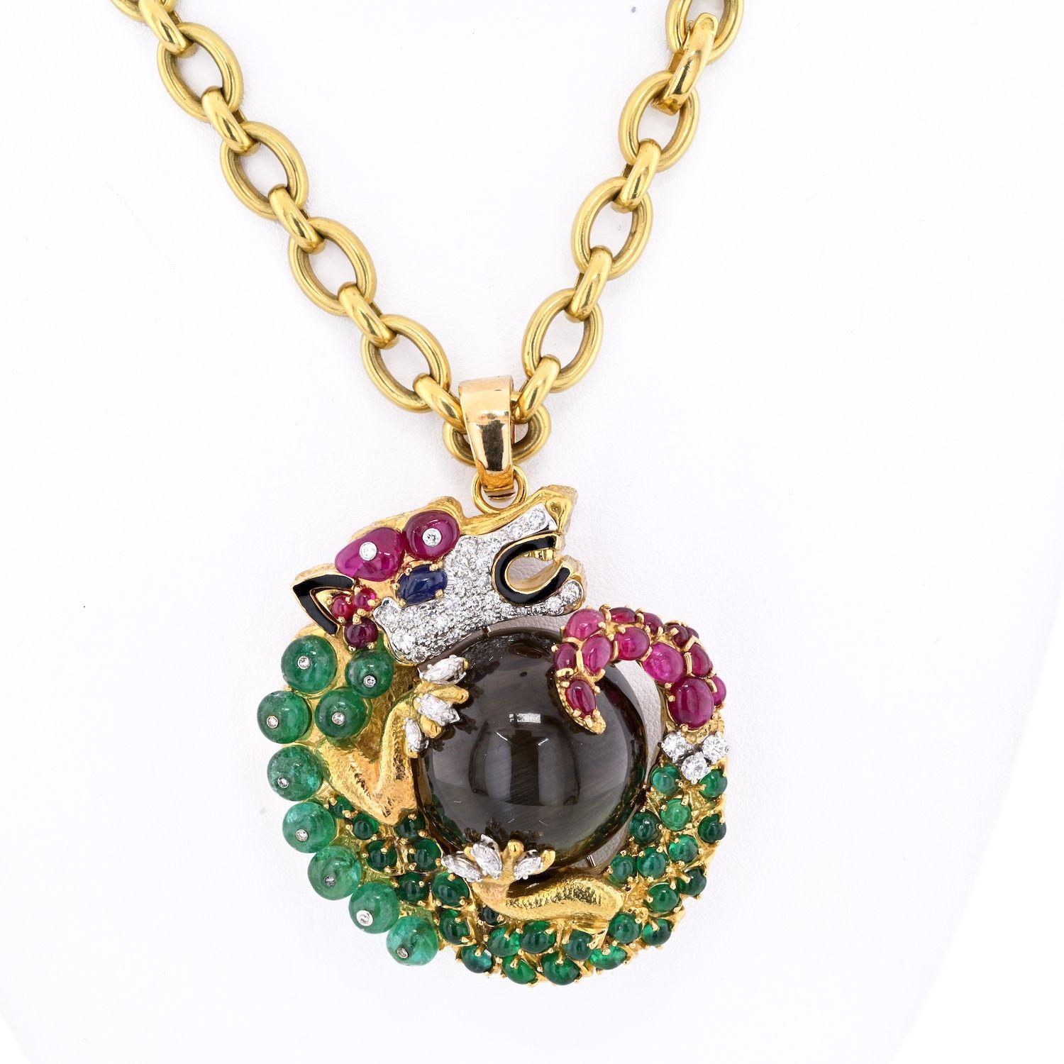 David Webb Multi-Gem Cat Eye Dragon bold pendant necklace.
This pendant is also a perfect brooch, like almost all David Webb's large pendants are. 
This one is very special: centered with a round cat's eye apatite cabochon, hoisted by a dragon with