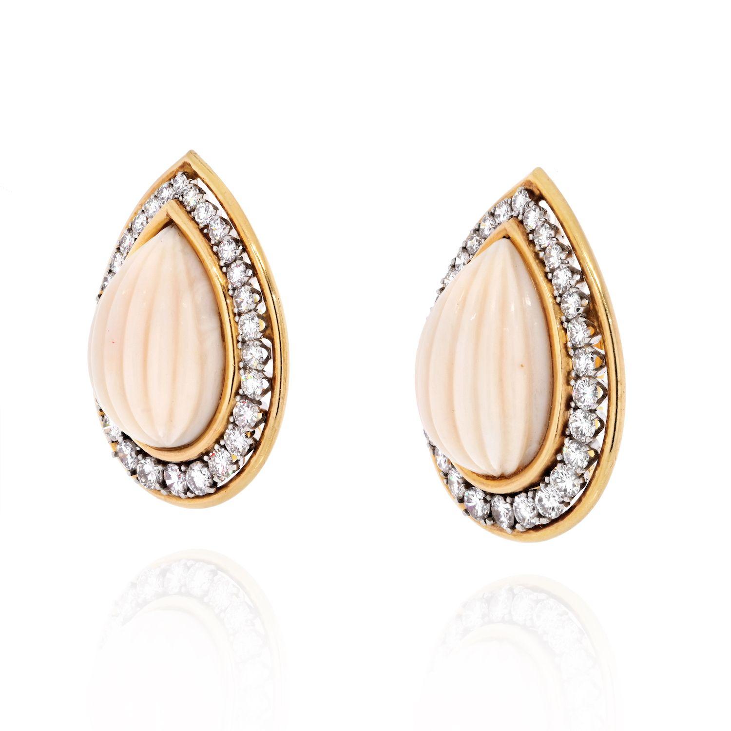 Light pink fluted coral earrings by David Webb. Impressive in size they measure about 1.1 inches in length these pear drop light pink coral earrings will complement someone with lighter skin tone and lighter short hair. The row of diamonds around