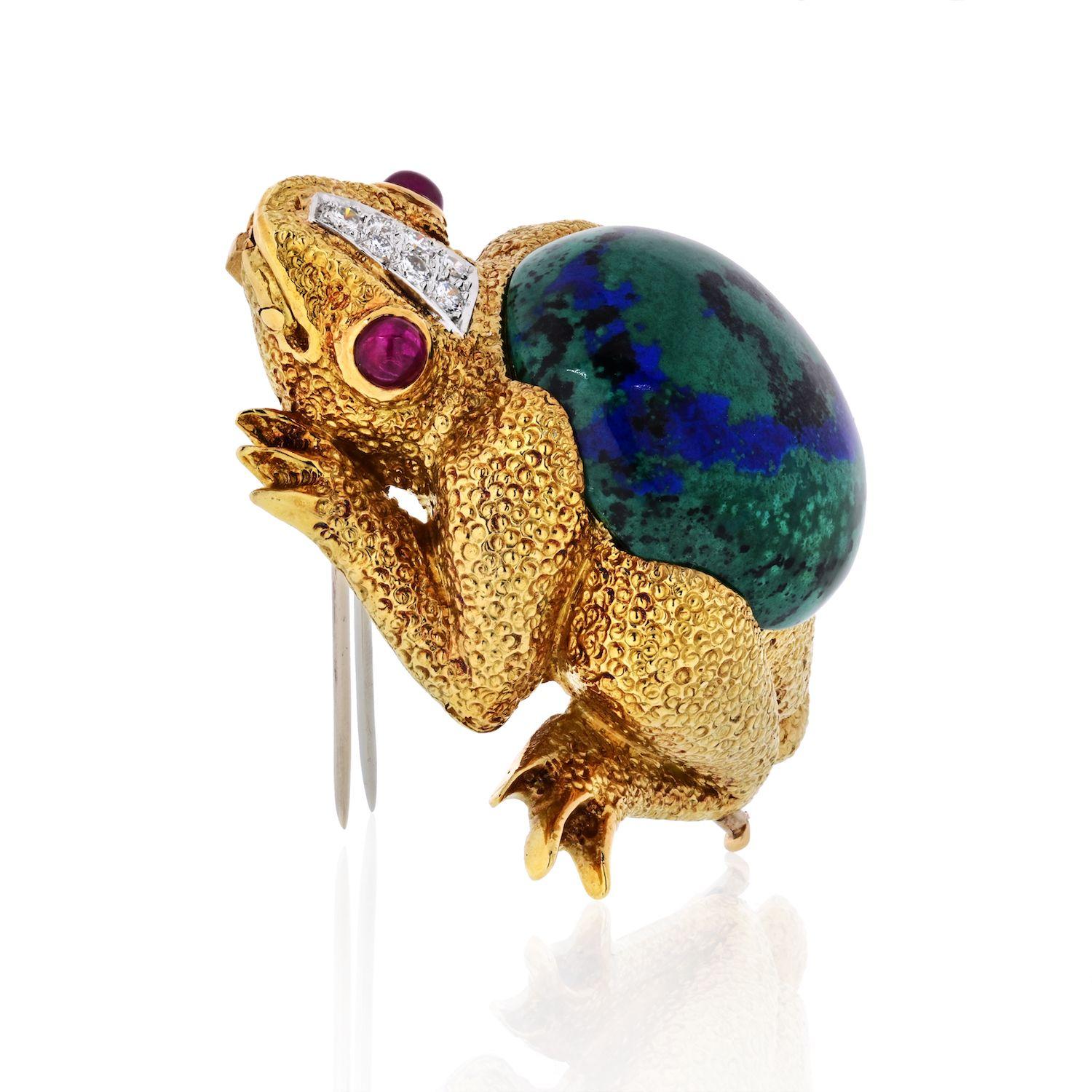 Part of the David Webb Kingdom Collection, this 18k and platinum frog brooch is exquisitely accentuated by diamonds, cabochon azurite and rubies. About 2 inches long. 49gr.
