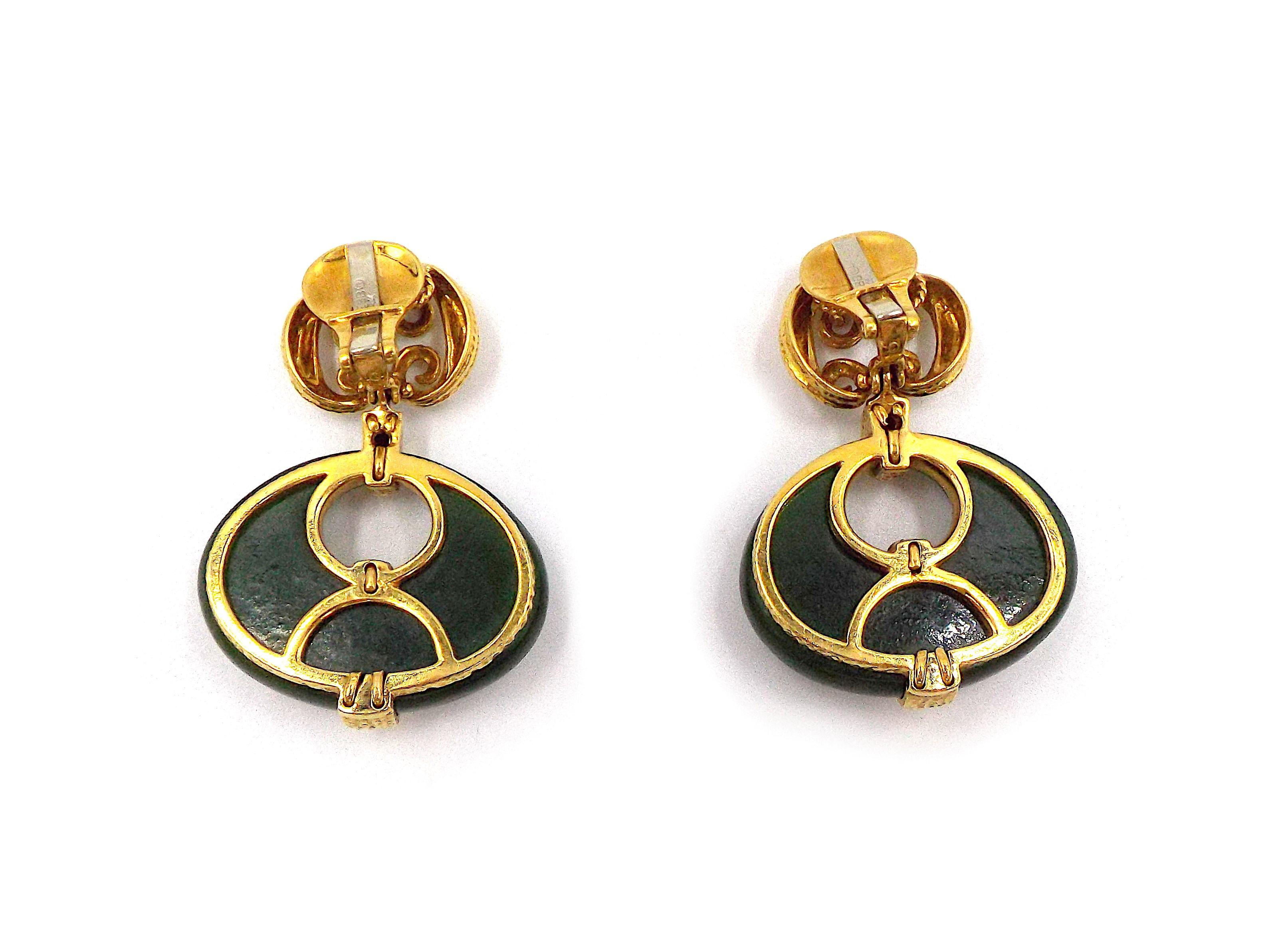 A pair of fancy 18K yellow gold earrings by David Webb. The top part is decorated with gold scroll motifs, the bottom part features massive jade door knocker shaped pendants. Each earrings weighs 26.2 grams, length is 1 7/8 inches, width is 1 3/8