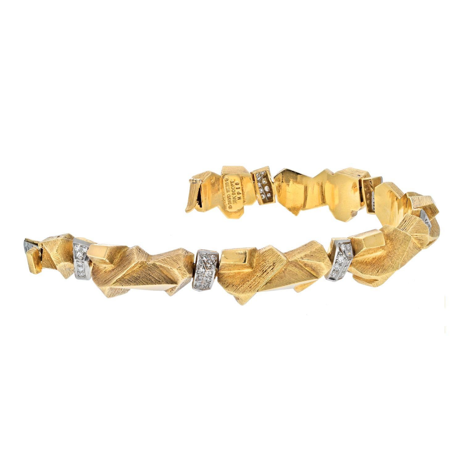This is an articulated yellow gold ski slope nugget bracelet by David Webb. It is made in a form of a gold slope nugget with diamond accents throughout. Comes with the certificate from David Webb.
Wrist size circumference: 8 inches.
Approximately